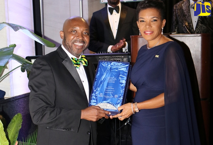 Jamaica’s Ambassador to Washington, Her Excellency Audrey Marks, receives the 2020 David “Wagga” Hunt Scholarship Foundation Award from Committee Member, Rev. Kingsley Gordon, at the eighth annual fundraising gala held at the Washington DC-based National Education Association on Saturday night (January 18).