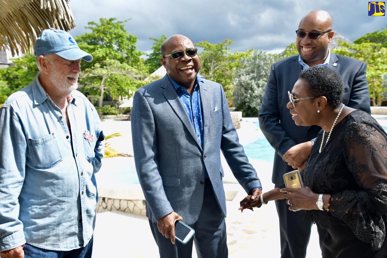 Minister of Tourism, Hon. Edmund Bartlett (second left), shares a light moment with Minister of Culture, Gender and Entertainment Hon. Olivia Grange (right); Businessman Chris Blackwell (left); and Chief Strategist/Adviser in the Ministry of Tourism, Delano Seiveright, at Golden Eye, St. Mary, recently.