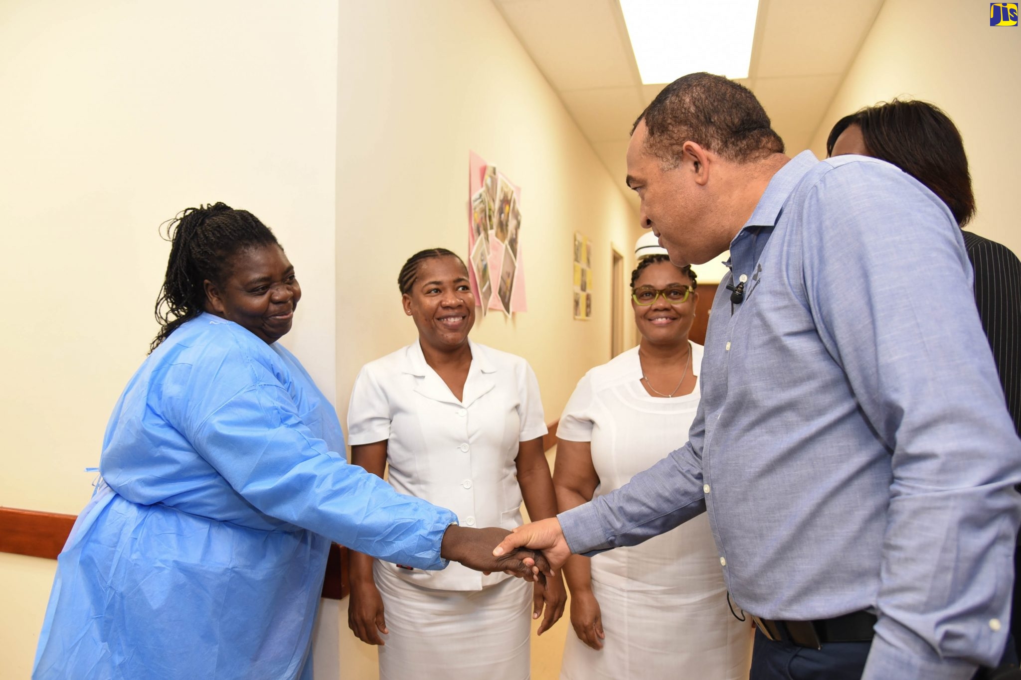 Minister of Health and Wellness, Dr. the Hon. Christopher Tufton (right), greets patient care assistant at the National Cancer Treatment Centre at St. Joseph’s Hospital, Nevido Jones, during a tour of the hospital on Tuesday (February 18). Sharing the moment (from left) are oncology nurses, Leona Dale and Cecile Francis-Patterson, while partially hidden is Director of Health Services, Planning and Integration, in the Ministry, Dr. Naydene Williams.