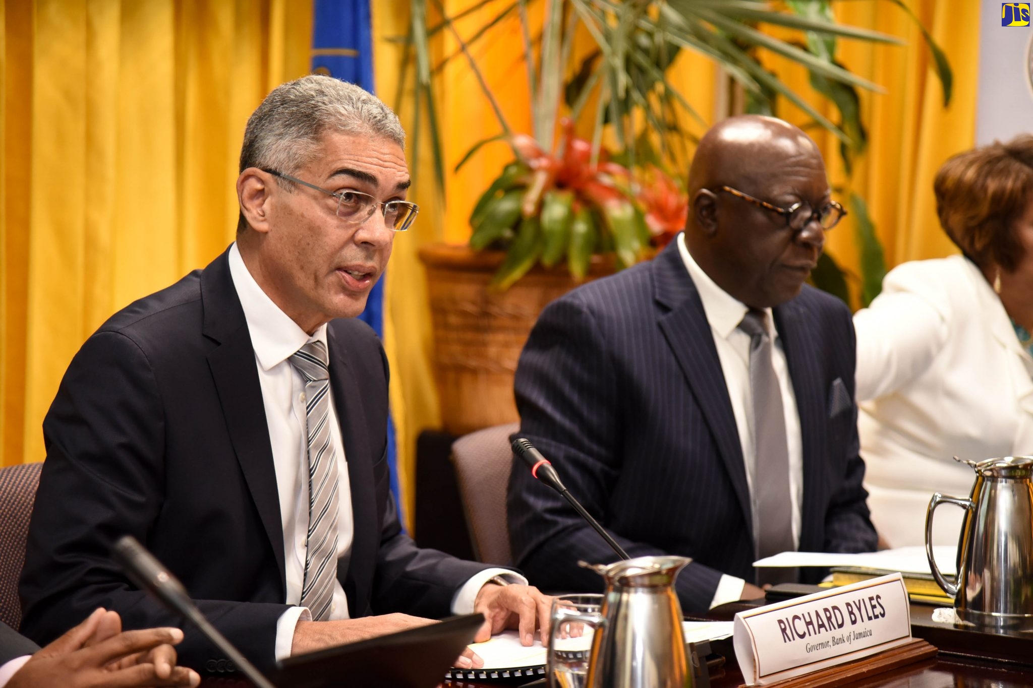 Bank of Jamaica (BOJ) Governor, Richard Byles (left), addresses journalists during Thursday’s (February 20) quarterly media briefing at the BOJ in downtown Kingston. At right is Senior BOJ Deputy Governor, John Robinson.