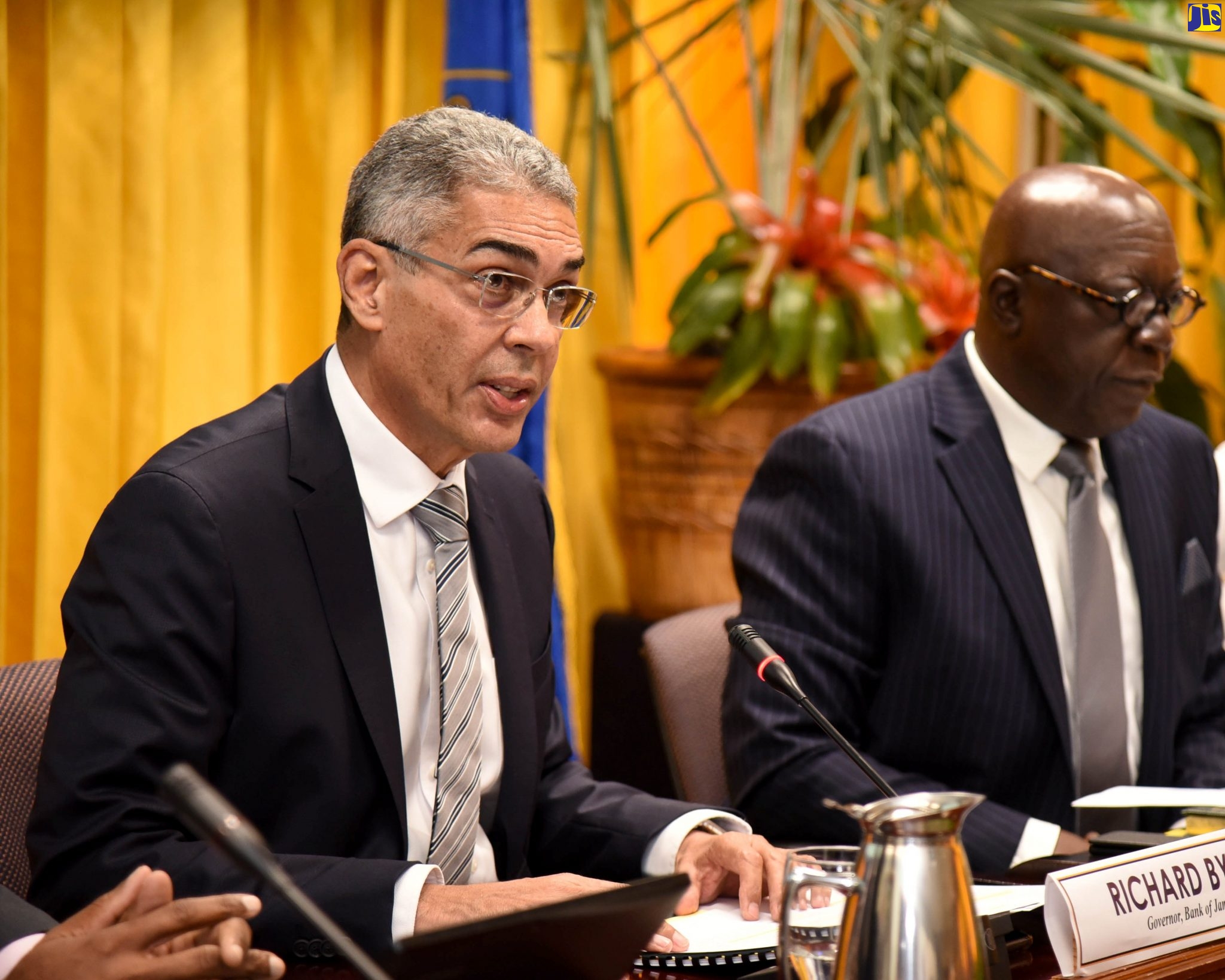 Bank of Jamaica (BOJ) Governor, Richard Byles (left), addresses journalists during Thursday’s (February 20) quarterly media briefing at the BOJ in downtown Kingston. At right is Senior BOJ Deputy Governor, John Robinson.