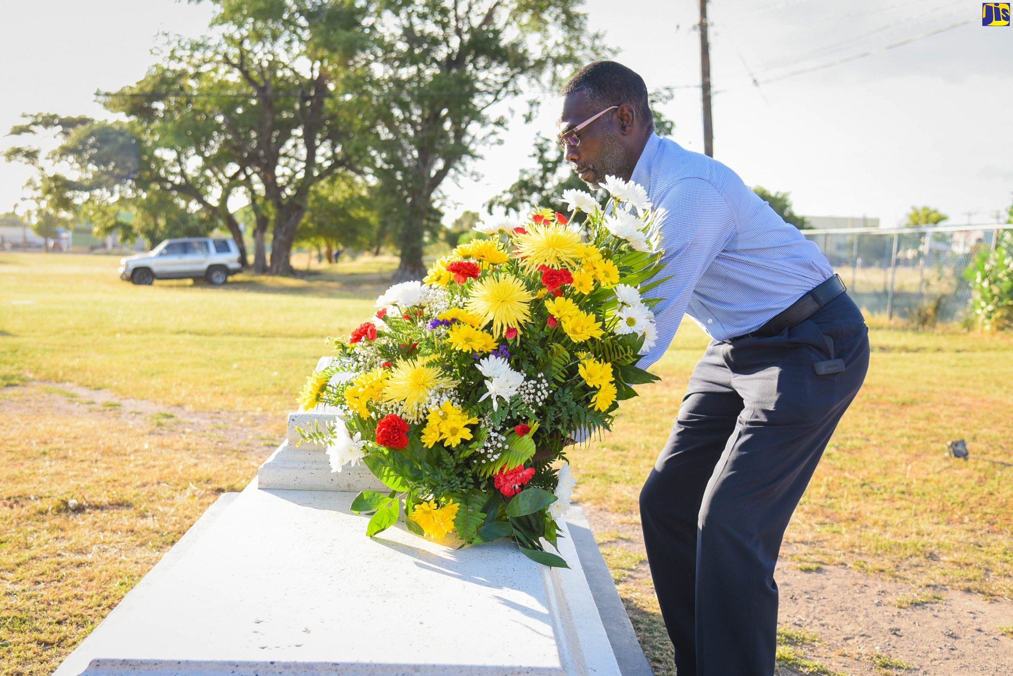 Permanent Secretary in the Ministry of Culture, Gender, Entertainment and Sport, Denzil Thorpe, places flowers at the grave of noted Reggae singer, Dennis Emmanuel Brown, CD, to commemorate the 63rd anniversary of his birth, at National Heroes Park, on February 1.