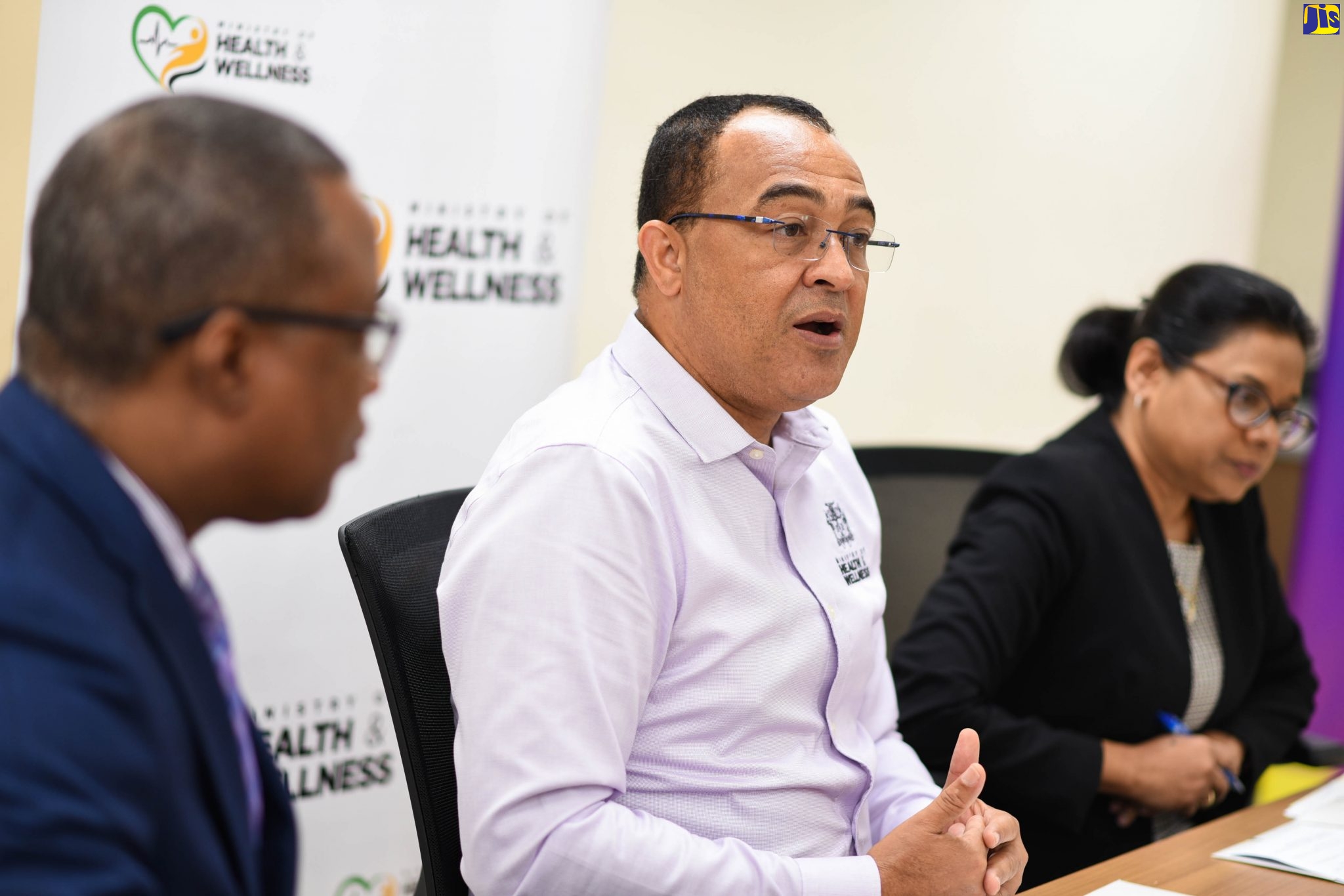 Minister of Health and Wellness, Dr. the Hon. Christopher Tufton (centre),addressing a press conference at the Ministry’s New Kingston offices on February 5. Listening (from left) are Permanent Secretary in the Ministry, Dunstan Bryan (left), and Chief Medical Officer, Dr. Jacquiline Bisasor-McKenzie.