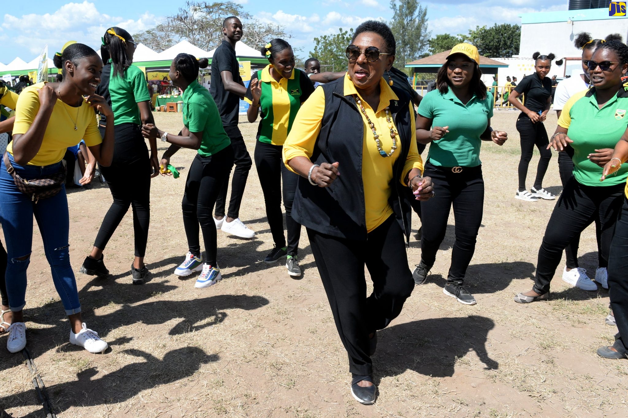 Minister of Culture, Gender, Entertainment and Sport, Hon. Olivia Grange (centre), joins in the recent Jamaica Day celebrations at the Denbigh High School in Clarendon.
