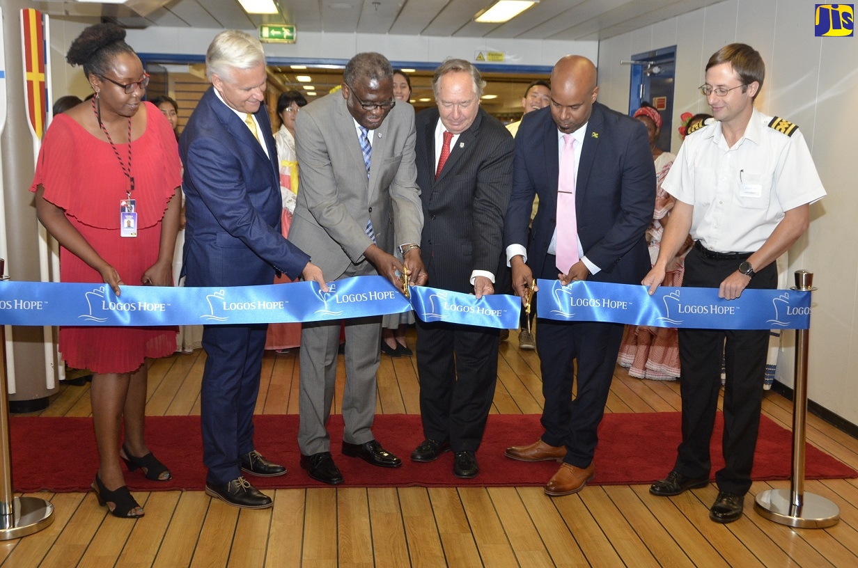 Custos Rotulorum of St. James, Bishop, the Hon. Conrad Pitkin (third left); and Councillor for the Spring Garden Division in St. James, Dwight Crawford (second right), cut the ribbon to officially open the Logos Hope book fair to the public, following a ceremony aboard the ship docked in Montego Bay on February 13. Sharing in the moment (from left) are Country Leader for charity OM Jamaica, Nichola Henry; Associate Director of Logos Hope, Randy Grebe; Custos Rotulorum for Trelawny, Hon. Paul Muschette; and Logos Hope Captain, James Berry.