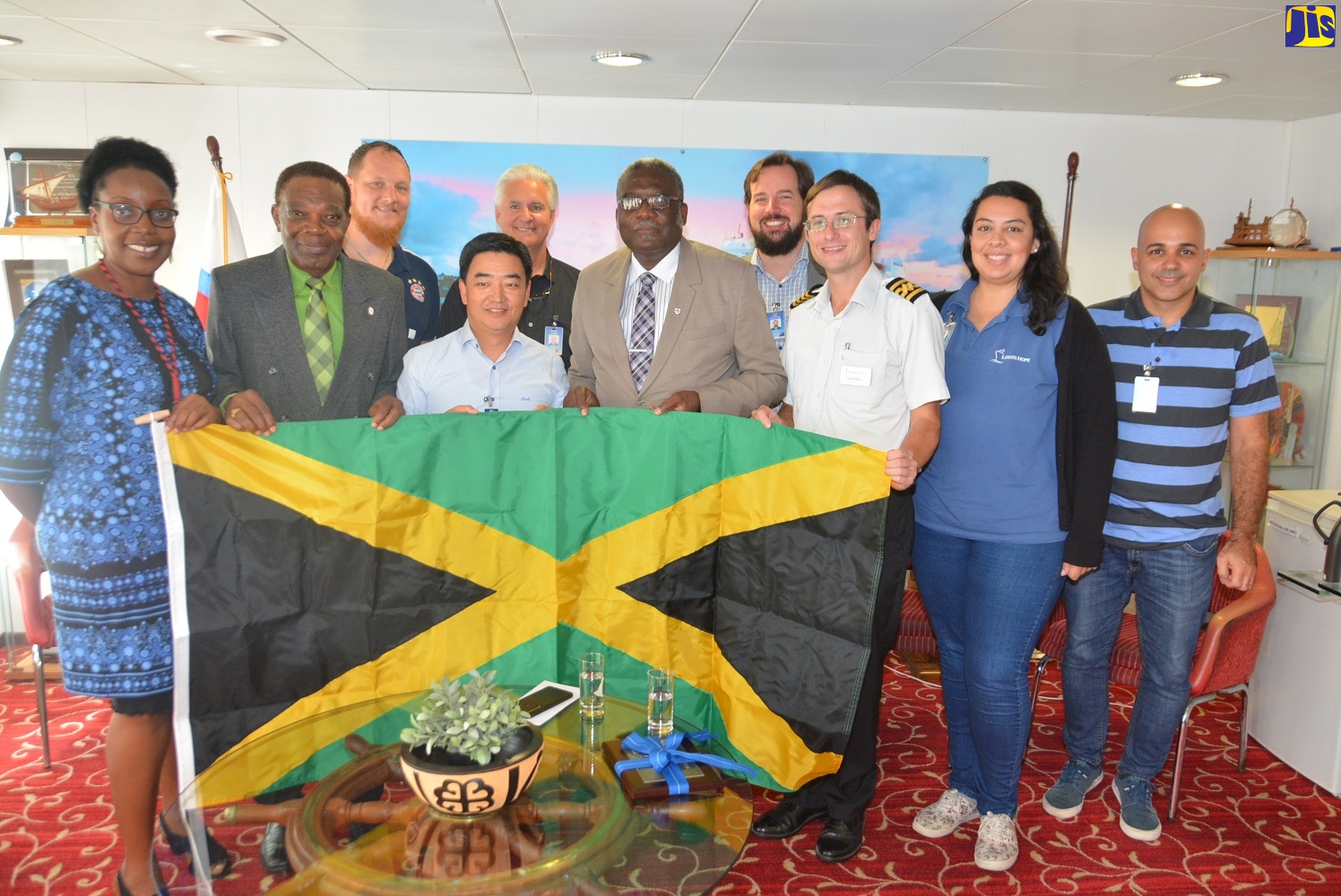 Custos Rotulorum for St. James, Bishop Conrad Pitkin (5th right) presents Jamaican flag to the Logos Hope crew, during a visit to the ship on Wednesday (February 19), which is docked in Montego Bay.