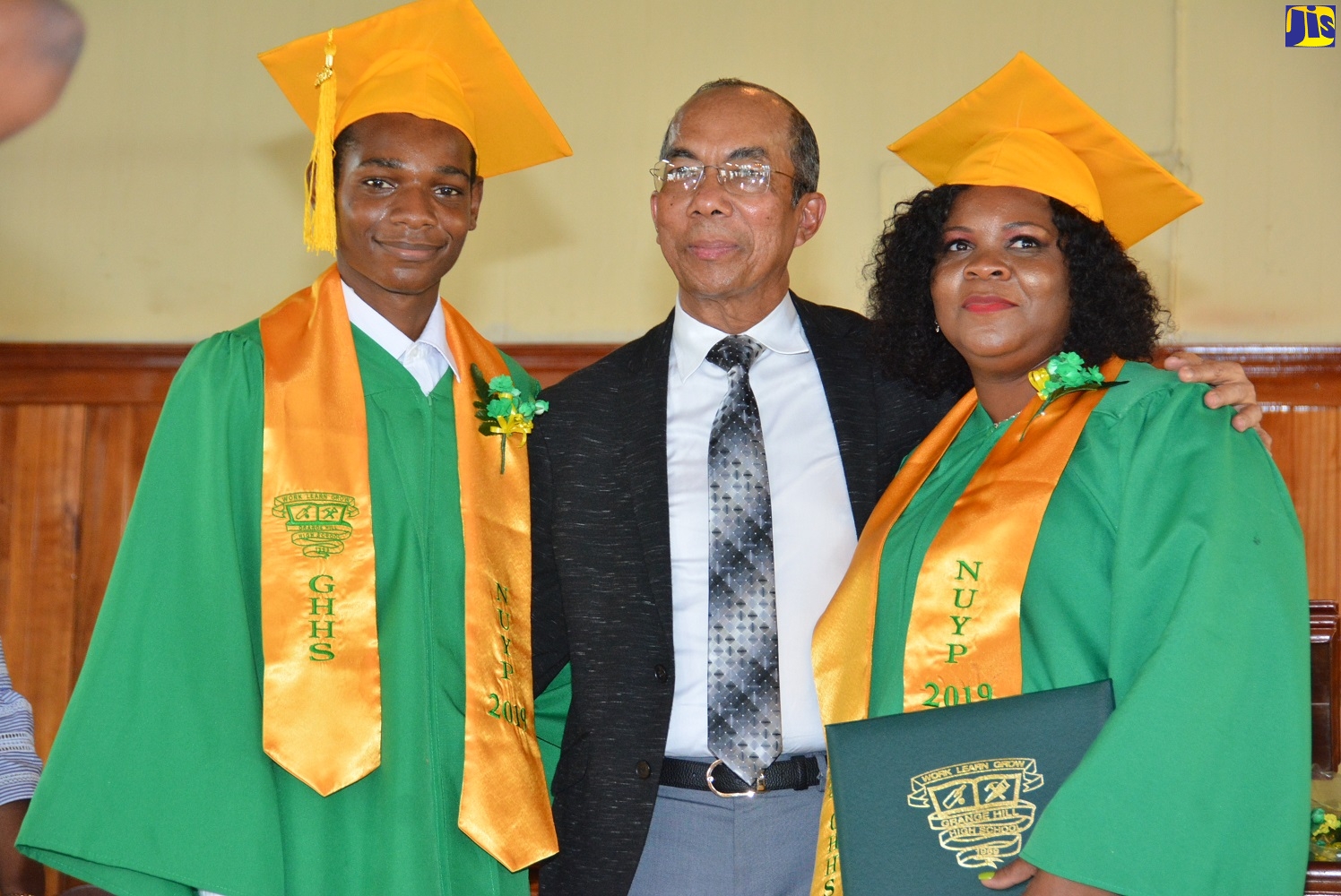 Minister of National Security, Hon. Dr. Horace Chang (centre), shares a moment with  Aneshia Brown (right) and her son Orlando Barrett. Occasion was the Grange Hill High School