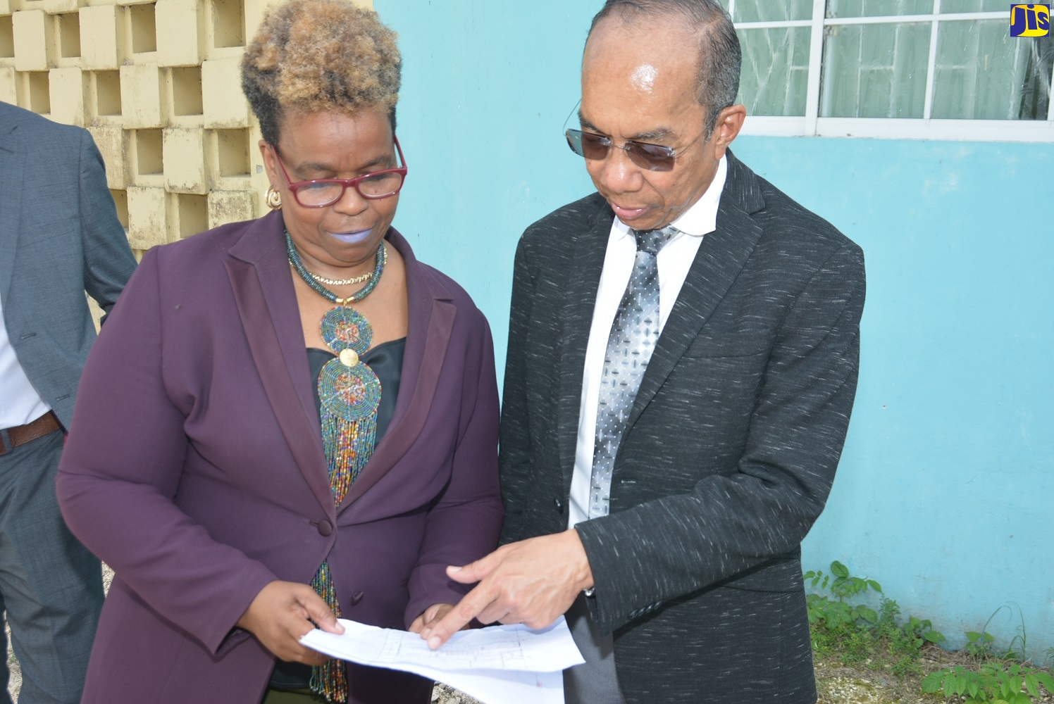Minister of National Security, Hon. Dr. Horace Chang (right), and Permanent Secretary in the Ministry, Dianne McIntosh, view the design for the construction of the $25 million motorcycle training facility at the Petersfield Vocational Training Center in Westmoreland during a site tour on Thursday, February 20.