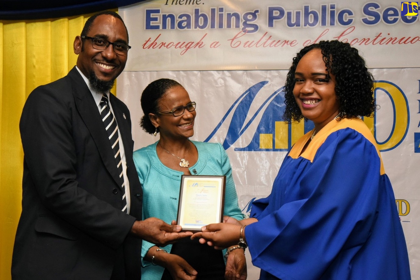 President of the Jamaica Civil Service Association, O’Neil Grant (left), presents a plaque to Management Institute for National Development (MIND) Top Performer, Shaniel Taylor (right), at the Institute’s 20th annual graduation exercise on Saturday (February 15) at The Knutsford Court Hotel in New Kingston. Looking on is Chief Executive Officer of MIND, Dr. Ruby Brown. President of the Jamaica Civil Service Association, O’Neil Grant (left), presents a plaque to Management Institute for National Development (MIND) Top Performer, Shaniel Taylor (right), at the Institute’s 20th annual graduation exercise on Saturday (February 15) at The Knutsford Court Hotel in New Kingston. Looking on is Chief Executive Officer of MIND, Dr. Ruby Brown.