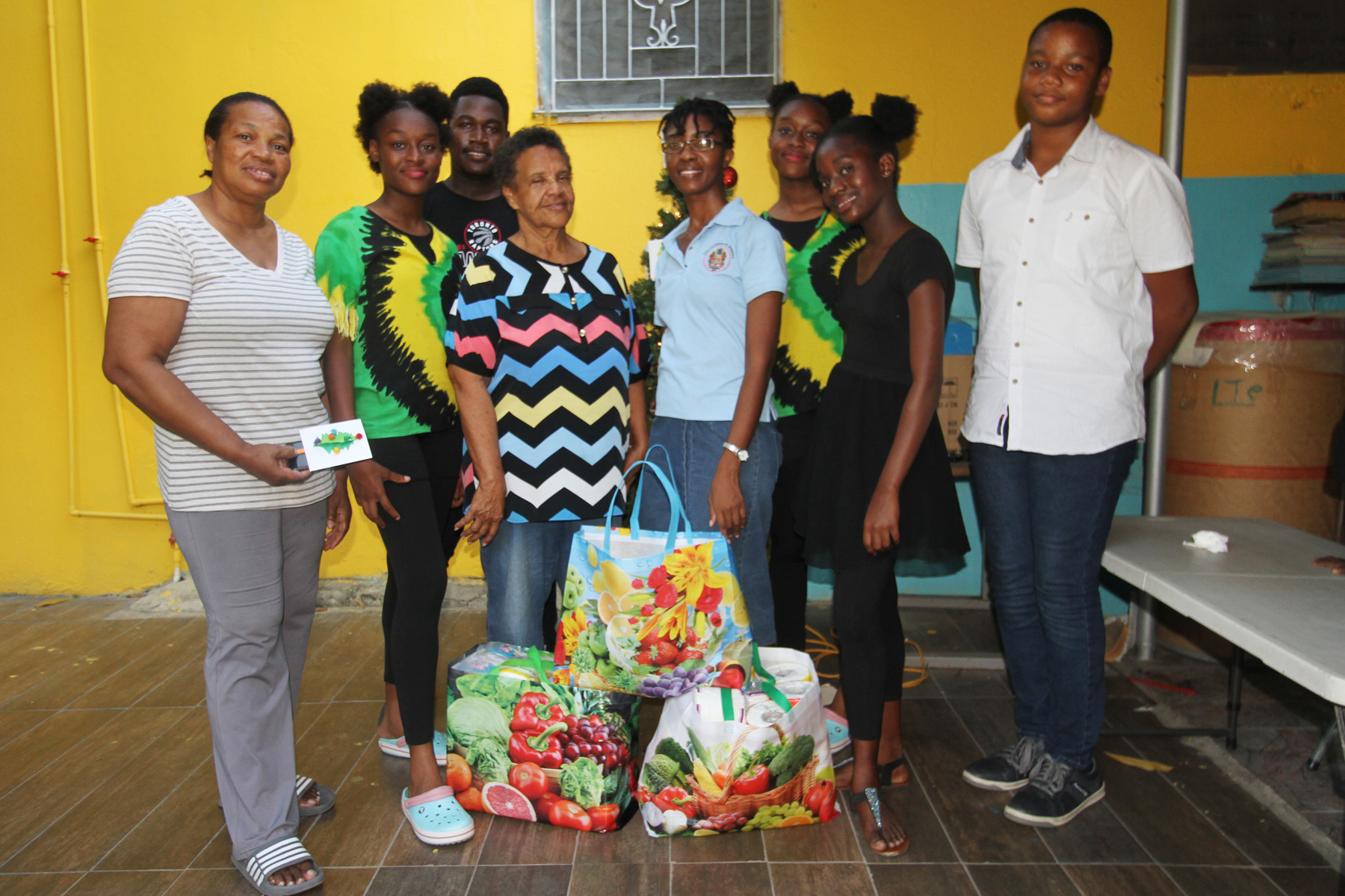 Children and staff from the Institute of Jamaica's Junior Centre pause for a photo op with staff of Reddie's Place of Safety during the handover ceremony. From left to right are: Miss Reddie, Care giver at Reddie's Place of Safety, Iyana Stewart, Sudent, Jaiden Whyte, student, Mrs. Clover Reddie-Brown, Manager of Reddie's Place of Safety, Ms. Kerri-Ann Palmer, Programmes Outreach Manager - East Street Junior Centre, Imani Stewart, Student, Machaela Jonas, Student, and, Rory Magnus, Student. 