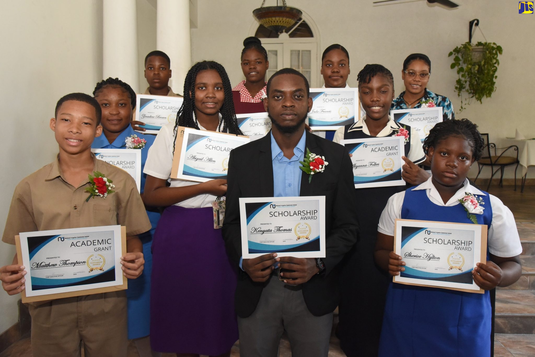 Recipients of the National Irrigation Commission (NIC) scholarships and grants valued at more than $1 million, display their certificates at an awards ceremony held on January 30 at the Four Seasons Hotel, in St. Andrew.