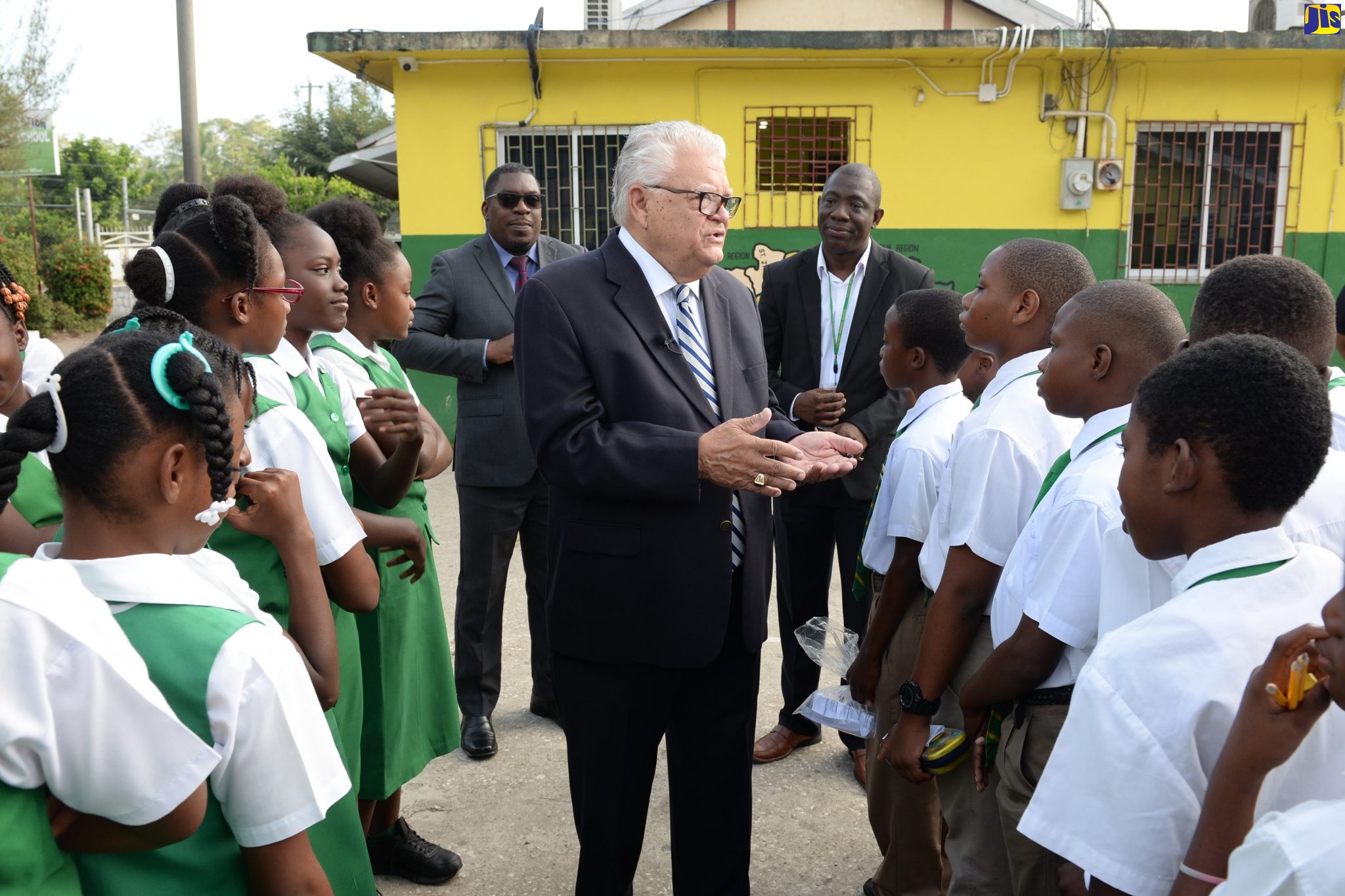 Minister with responsibility for Education, Youth and Information, Hon. Karl Samuda, speaks with grade-six students at Tulloch Primary School in Bog Walk, St. Catherine, ahead of the sitting of the Primary Exit Profile (PEP) Ability Test this morning (February 25). Looking on in the background are Director for Region 6, Barrington Richardson (left), and Principal of the school, Dameon Hinds.