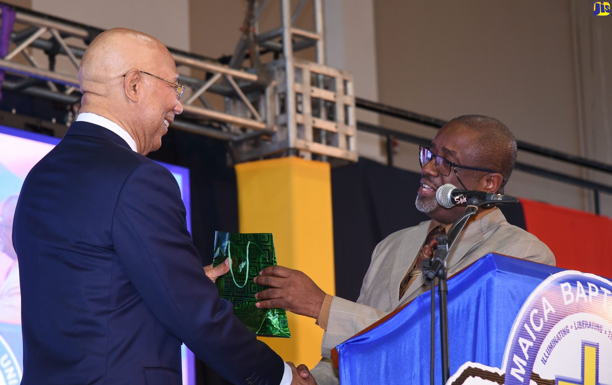 Governor General, His Excellency the Most Hon. Sir Patrick Allen (left), accepts a gift from General Secretary of the Jamaica Baptist Union (JBU), Rev. Karl B. Johnson, at the JBU’s 170th General Assembly, held at the National Arena, on February 23.