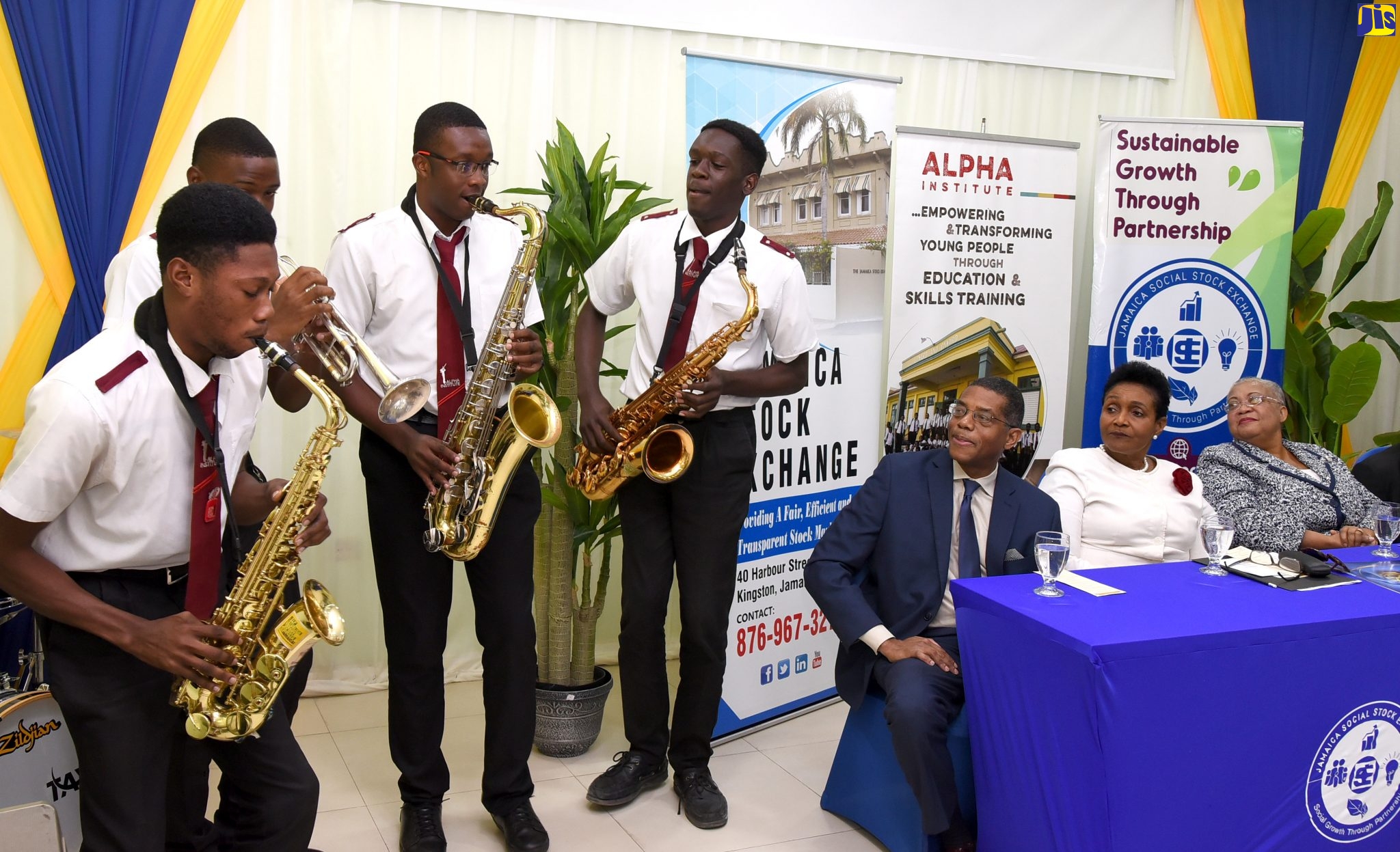 Members of the Alpha Band perform during the Letter of Intent signing ceremony among the Consulate of Jamaica in Philadelphia; the Jamaica Stock Exchange (JSE) and the Jamaica Social Stock Exchange (JSSE), to raise capital for the Alpha Institute. The ceremony took place at the JSE’s office, 40 Harbour Street in downtown Kingston. Enjoying the performance (from left) are Jamaica’s Honorary Consul in Philadelphia, Christopher Chaplin; Permanent Secretary in the Ministry of Foreign Affairs and Foreign Trade, Ambassador Marcia Gilbert-Roberts; and Managing Director, Jamaica Stock Exchange (JSE), Marlene Street Forrest.