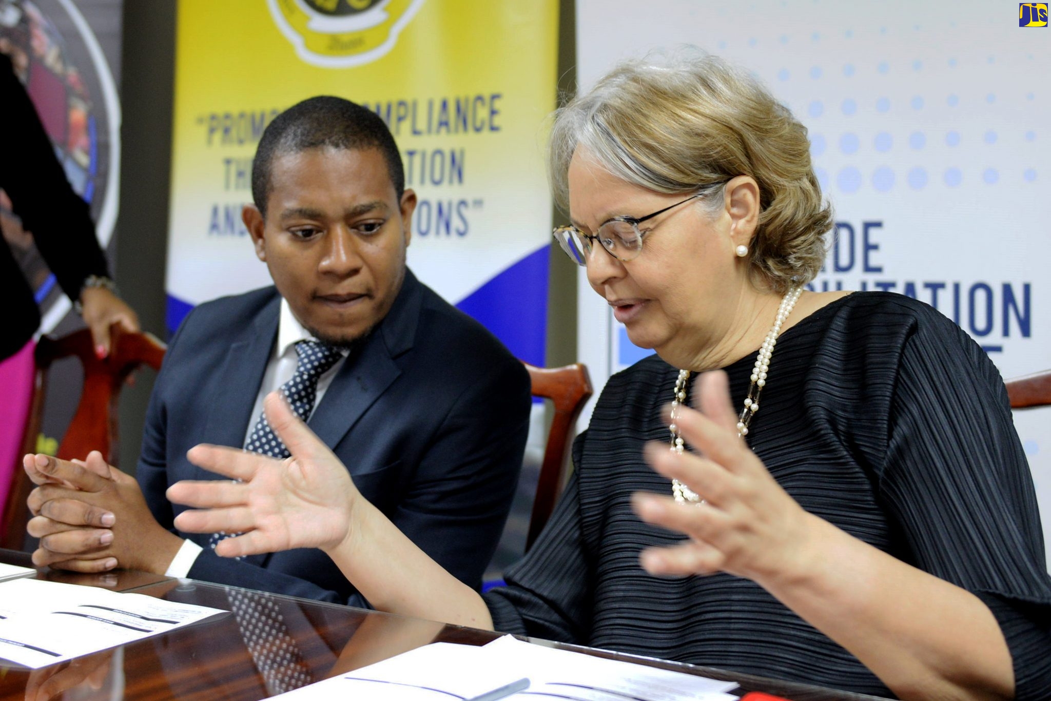 Minister of State in the Ministry of Industry, Commerce, Agriculture and Fisheries, Hon. Floyd Green (left), converses with Chairman, Trade Facilitation Task Force, Patricia Francis, at a private-sector-engagement breakfast held on February 27 at the Ministry of Finance and the Public Service, Heroes Circle, Kingston.