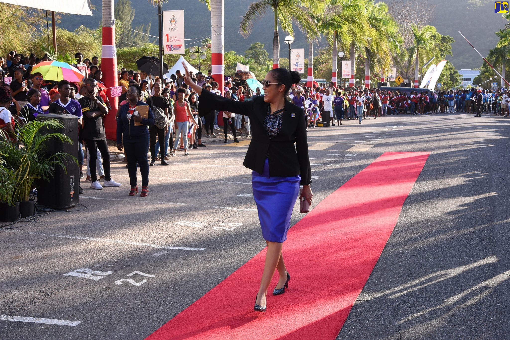 Chief Executive Officer, Jamaica Information Service (JIS), Donna-Marie Rowe, walks the red carpet during the University of the West Indies, Mona, Homecoming Commemoration Ceremony’s ‘Walk of Pride’, held at the campus on Thursday (February 13).