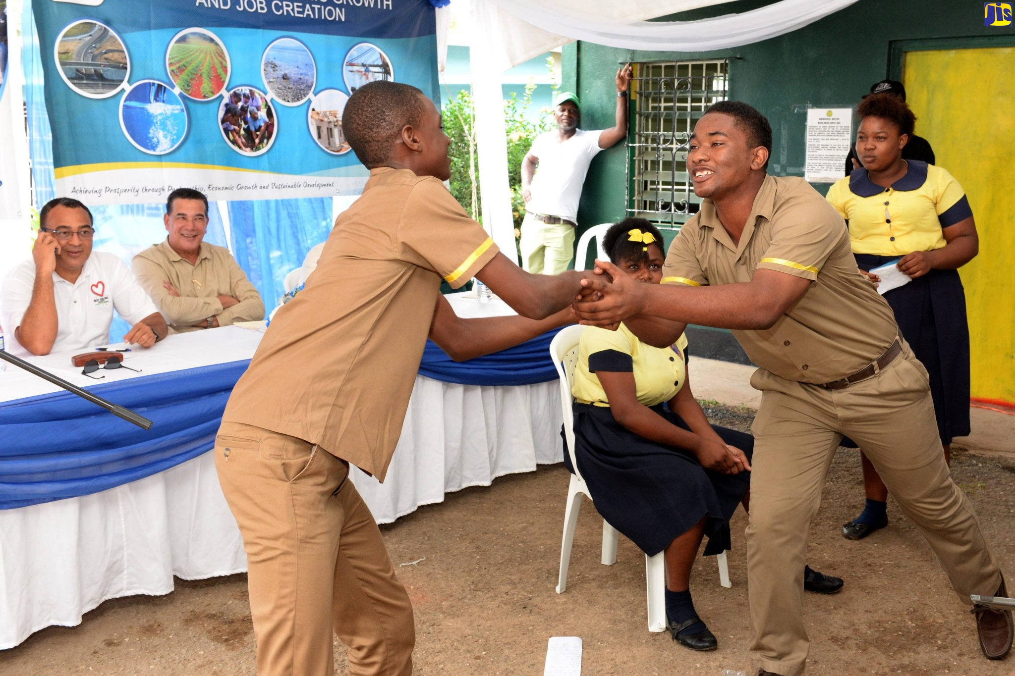 Member of Parliament for West Central St. Catherine, and Minister of Health and Wellness (left), Dr. the Hon. Christopher Tufton (left), enjoys the performance of students from the Tacius Golding High School in St. Catherine, at the ground-breaking ceremony for the $150-million Watermount Water Supply System, on February 19. Also enjoying the performance at second left is Chairman of the Rural Water Supply Limited (RWSL), Councillor Homer Davis.