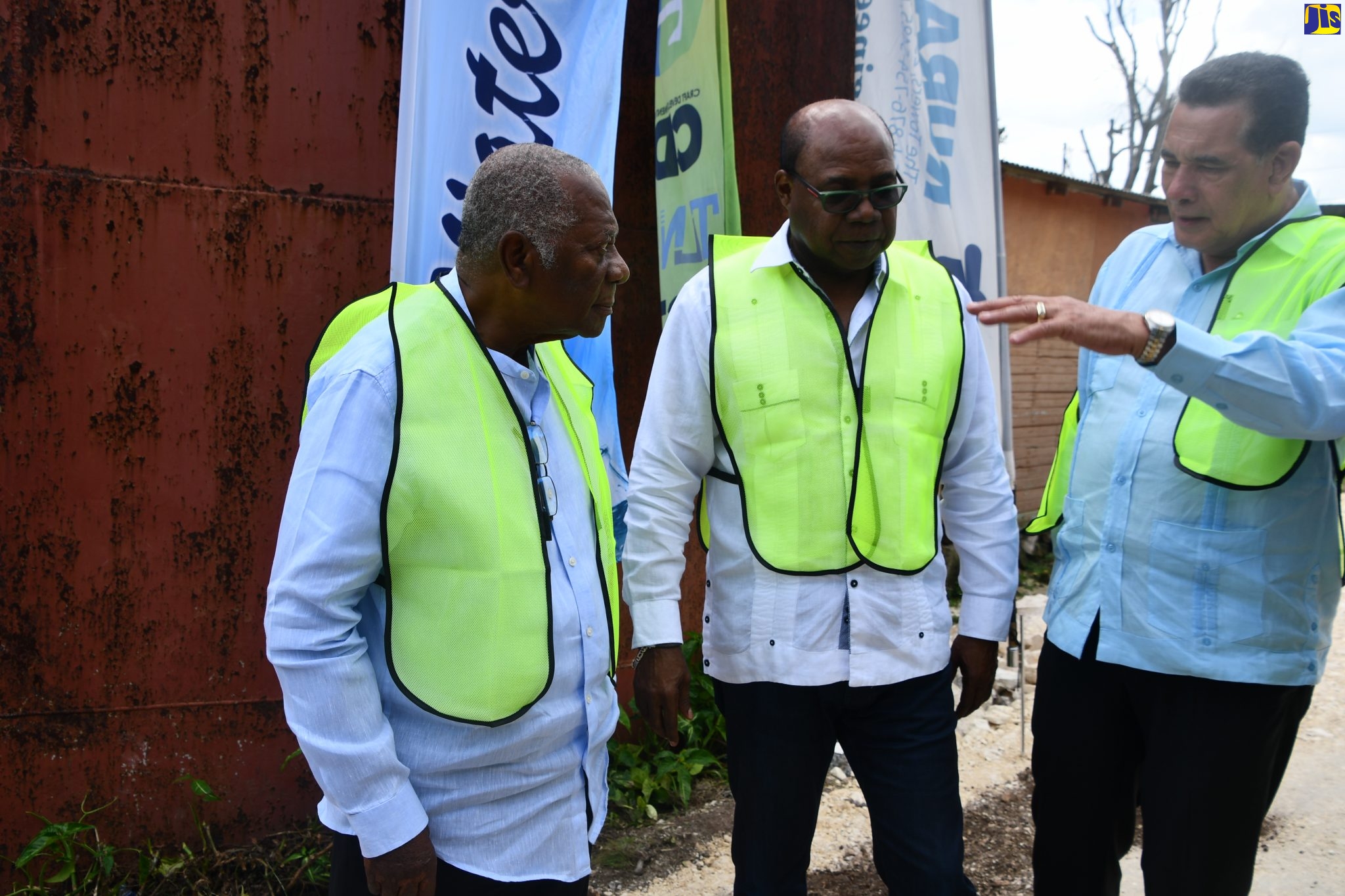 Minister of Tourism, Hon. Edmund Bartlett (centre), engages in a discussion with Chairman of the Tourism Enhancement Fund (TEF) Godfrey Dyer (L); and Mayor of Montego Bay, Councilor Homer Davis, at the ceremony to break ground for the Canaan/Adelphi Water Supply System in Somerton, St. James, on February 5.