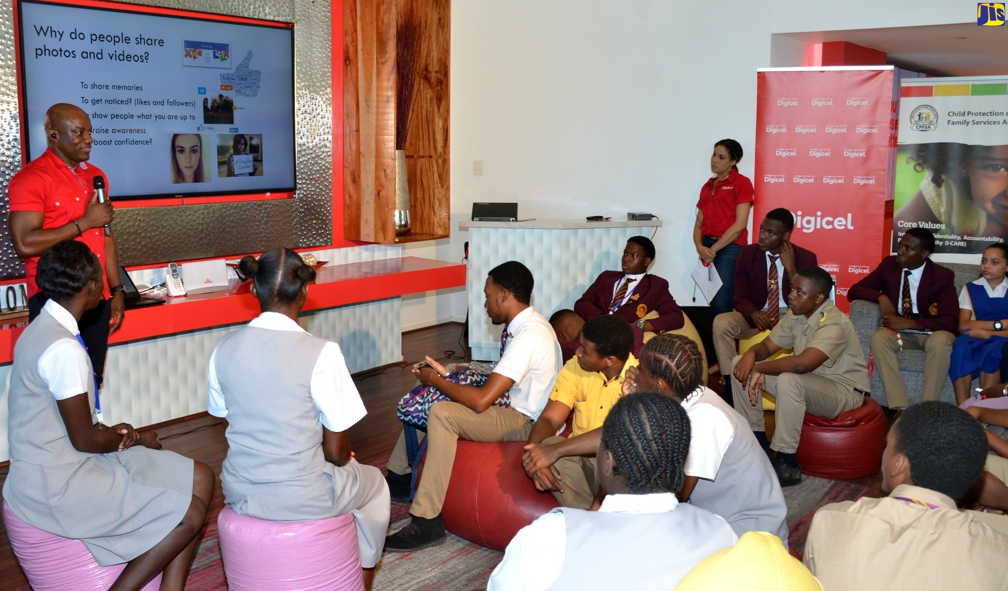 Head of Public Relations at Digicel, Elon Parkinson, speaks with students during a rap session at Digicel Iconic Store in downtown Kingston, on Tuesday (February 11), hosted by the Child Protection and Family Services Agency (CPFSA) and Digicel in observance of ‘Safer Internet Day’.