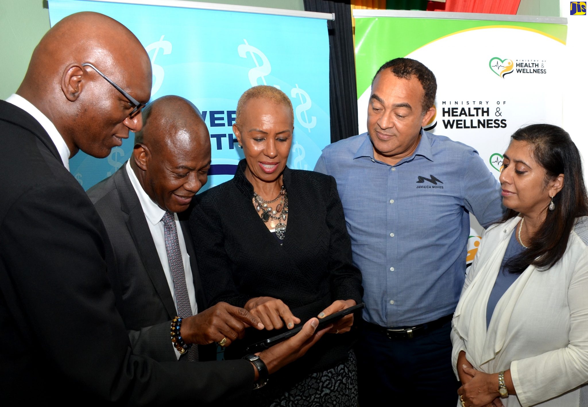 Health and Wellness Minister, Dr. the Hon. Christopher Tufton (2nd right), looks on as Science, Energy and Technology Minister, Hon. Fayval Williams (centre), uses a tablet to test internet speed at the Kingston Public Hospital (KPH). Occasion was a signing ceremony to increase bandwidth allocation to the KPH, Victoria Jubilee Hospital (VJH) and the South East Regional Health Authority (SERHA), at the KPH’s North Street address in Kingston on February 18. Others (from left) are Director of Management Information Systems, SERHA, Jaime Robinson; Chief Executive Officer, Universal Service Fund (USF), Daniel Dawes; and Chair, USF Board of Management, Dr. Gunjan Mansingh.