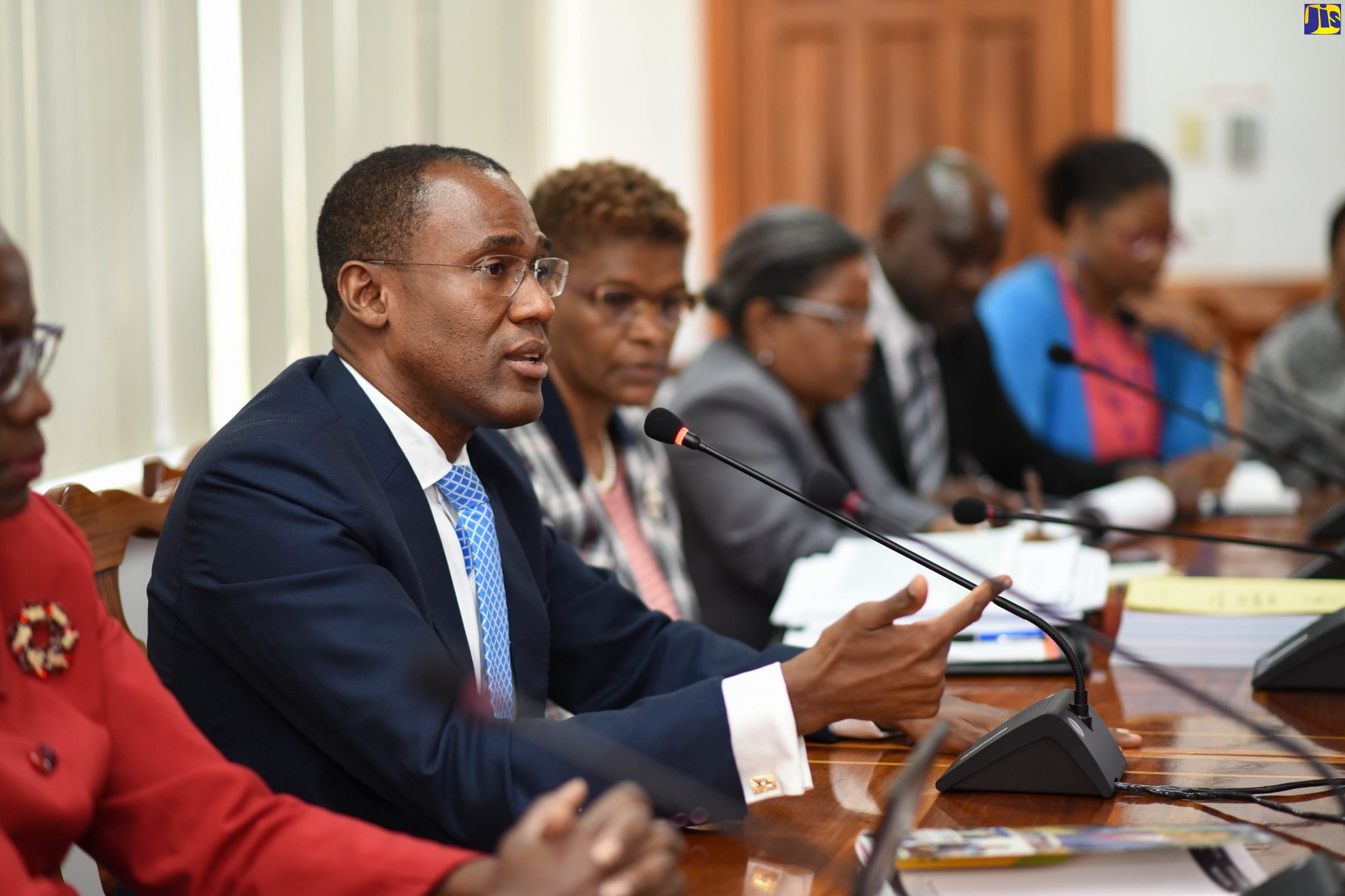 Minister of Finance and the Public Service, Dr. the Hon. Nigel Clarke (second left), addresses journalists during Wednesday’s (March 11) post-Budget press briefing at the Ministry’s offices in Kingston. With him are officers of the Ministry.