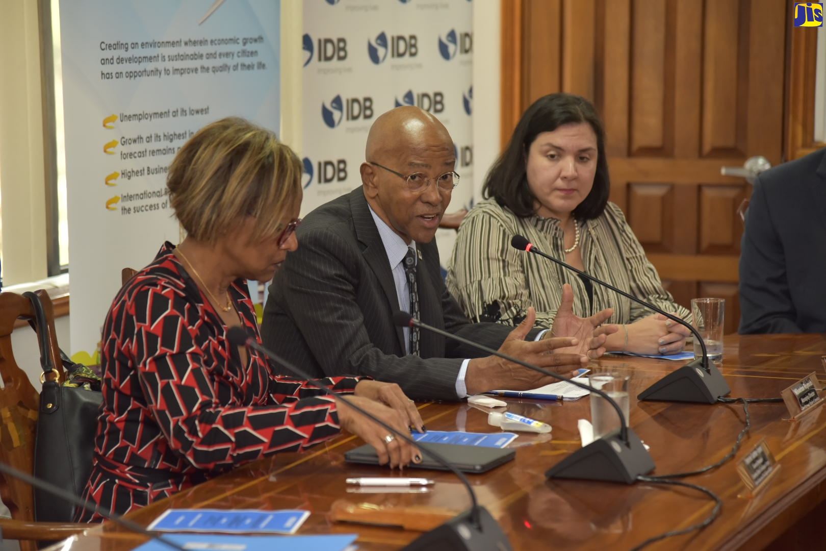 Managing Director of the Development Bank of Jamaica (DBJ), Milverton Reynolds (centre), speaks during the recent signing ceremony for the US$50-billion Inter-American Development Bank (IDB)-funded Boosting Innovation, Growth and Entrepreneurship Ecosystems (BIGEE) Programme at the Ministry of Finance and the Public Service in Kingston. The project, which targets funding and technical assistance support for micro, small and medium-sized enterprises (MSMEs), will be executed by the DBJ. Listening (from left) are IDB Caribbean Group Country Department General Manager, Therese Turner Jones; and Chief of Operations, Adrianna La Valley.