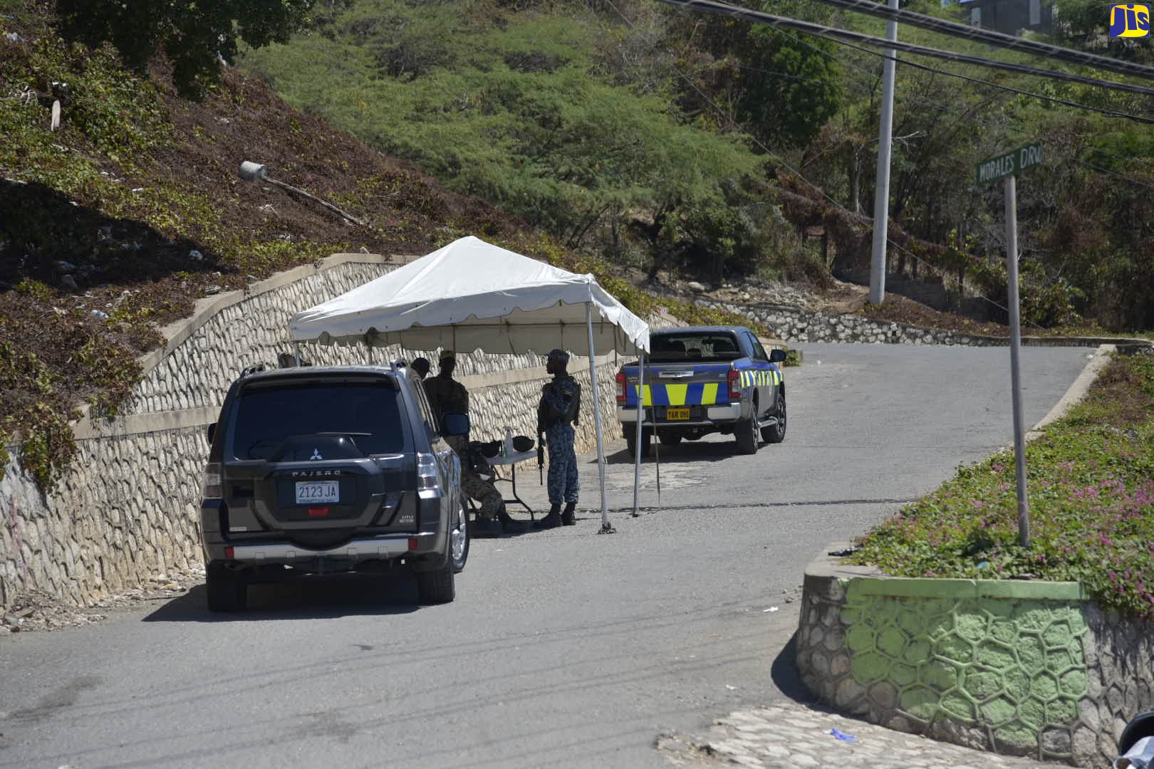 Members of the security forces at a check point at Morales Drive in the Seven Miles community of Bull Bay, St. Andrew on Saturday morning (March 14). The Seven and Eight Miles communities have been placed under quarantine to contain the spread of the coronavirus (COVID-19). This follows a Declaration Order by Prime Minister, the Most Hon. Andrew Holness, designating the entire island a disaster area, under the Disaster Risk Management Act. The decision was taken to quarantine the communities after a number of persons, who are linked to the first individual, who tested positive for the virus (patient zero), started showing symptoms that suggested that they are ill or becoming ill.