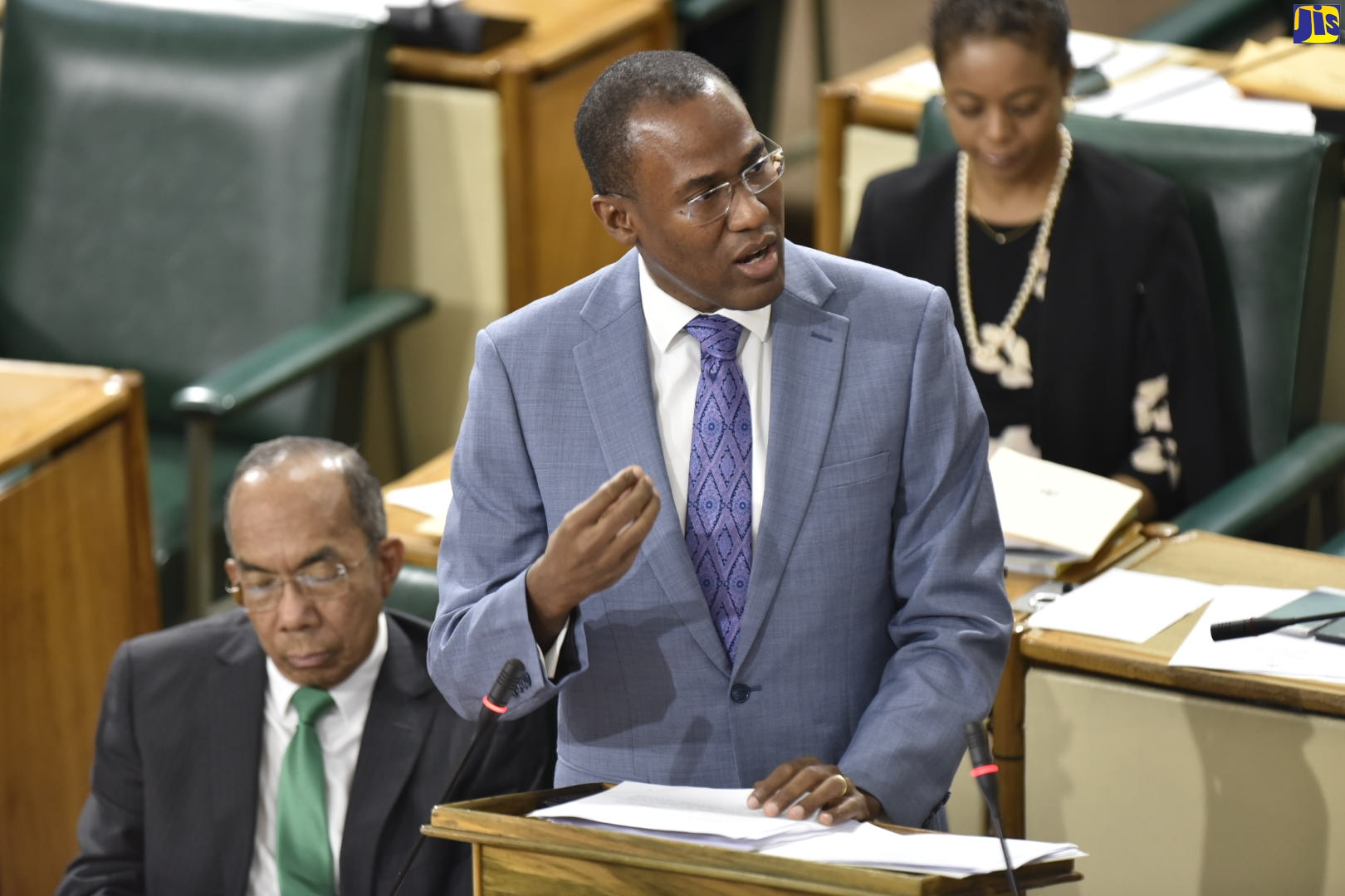 Minister of Finance and the Public Service, Dr. the Hon. Nigel Clarke, opens the 2020/21 Budget debate in the House of Representatives on March 10. At left is National Security Minister, Hon. Dr. Horace Chang, while Attorney General, Hon. Marlene Malahoo Forte is in the background.