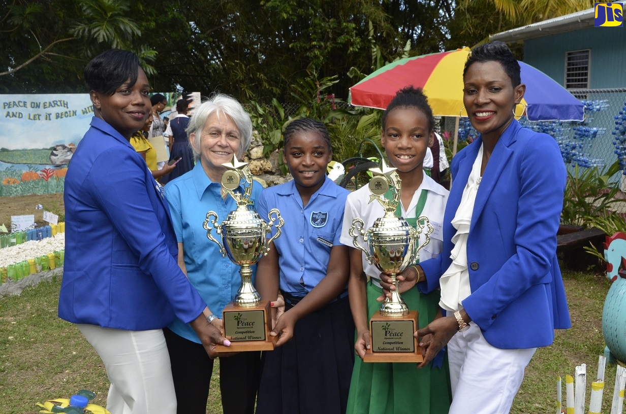 Chair of Violence Prevention Alliance (VPA), Dr. Elizabeth Ward (second left), presents a trophy to Principal of the Upper Rock Spring All-Age and Infant School in Hanover, Faithlyn Walters Meylor; and grade-six student, Tahaelia McIntyre; while grade-six student at Maryland All-Age in Hanover, Jody-Ann Hylton (second right) and Principal of the school, Andria Dehaney-Grant, show off their trophy. Occasion was the VPA awards ceremony held on March 3 on the grounds of the Maryland All-Age. The institutions were joint winners of the VPA’s 2020 Trees for Peace competition.