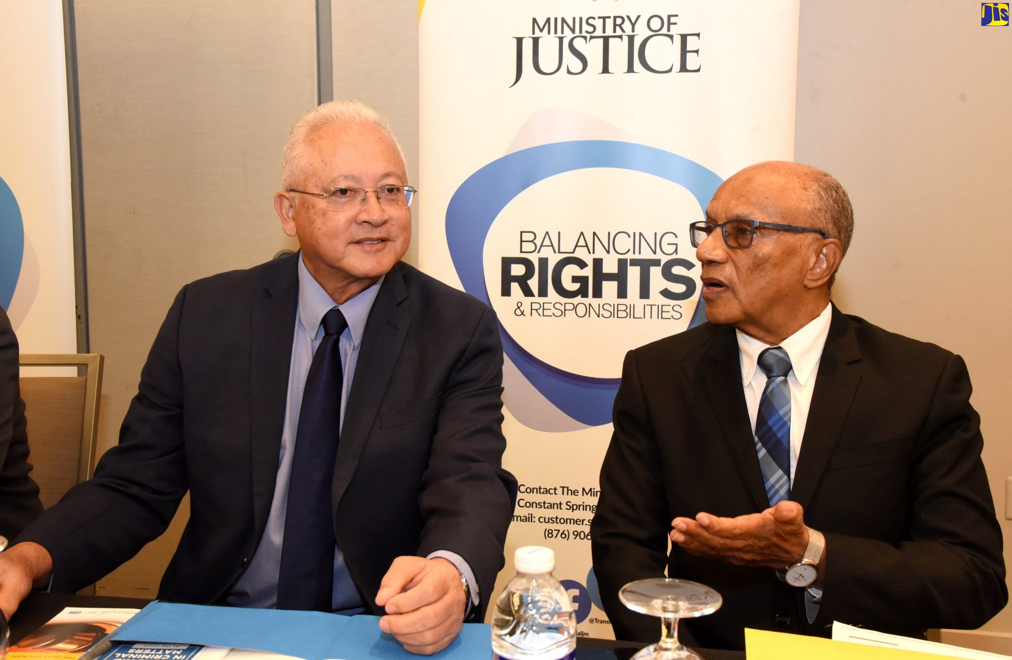 Justice Minister, Hon. Delroy Chuck (left); and Executive Director of National Integrity Action (NIA), Professor Trevor Munroe, are in discussion at a Legal Aid Council (LAC) sensitisation session held recently in Kingston.