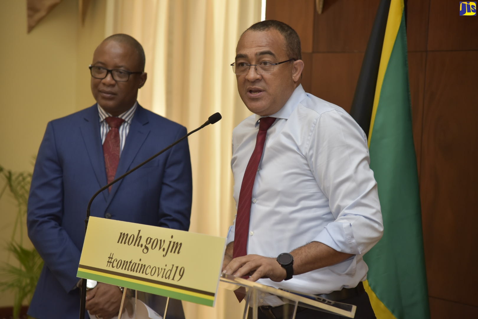 Minister of Health and Wellness, Dr. the Hon. Christopher Tufton (right), addresses the media at a press conference at Jamaica House, on Tuesday (March 18). With the Minister is Permanent Secretary in the Ministry, Dunstan Bryan.