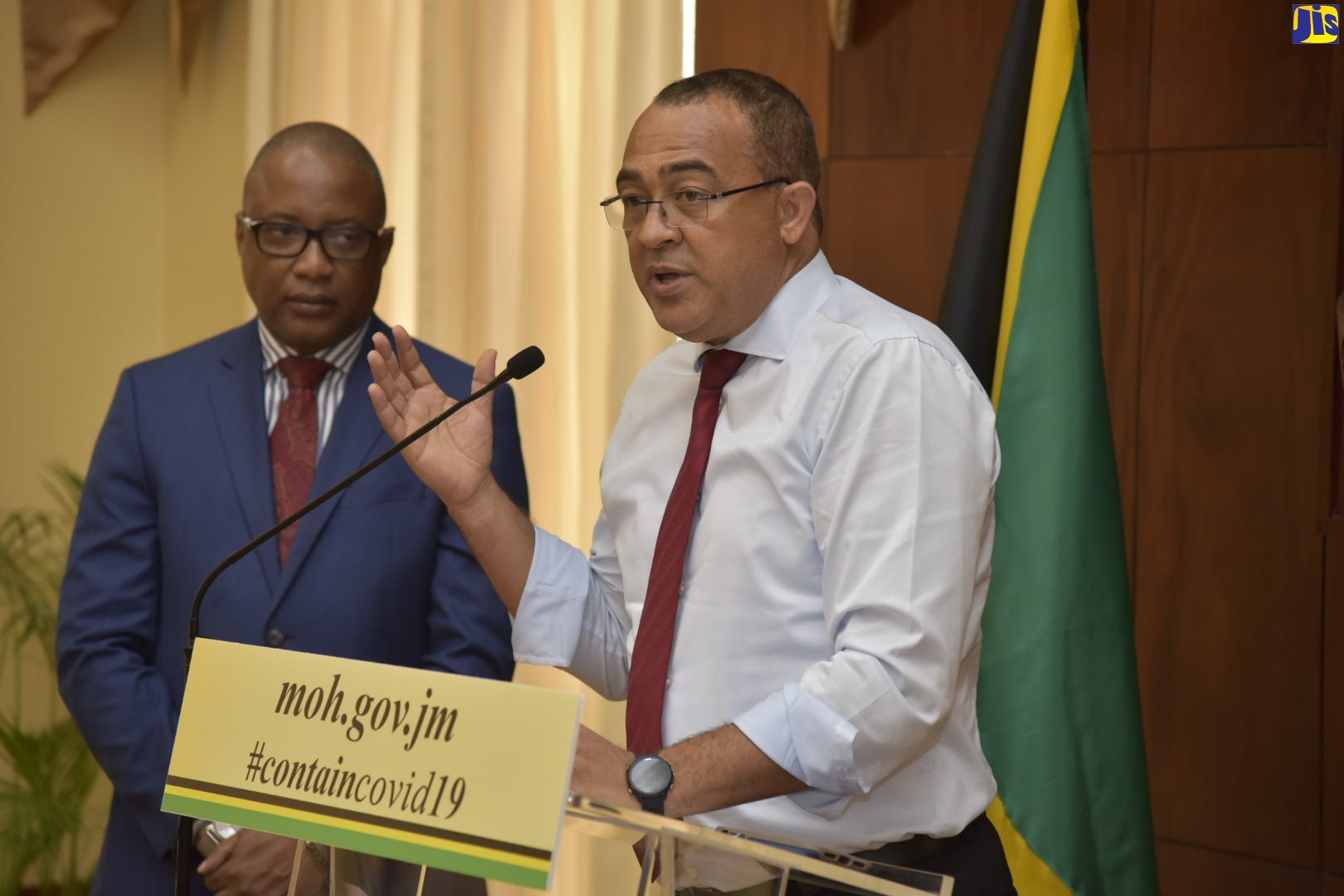 Minister of Health and Wellness, Dr. the Hon. Christopher Tufton (right) addressing a press conference at Jamaica House on Tuesday (March 17). Standing beside him is the Permanent Secretary, Ministry of Health and Wellness, Dunstan Bryan.