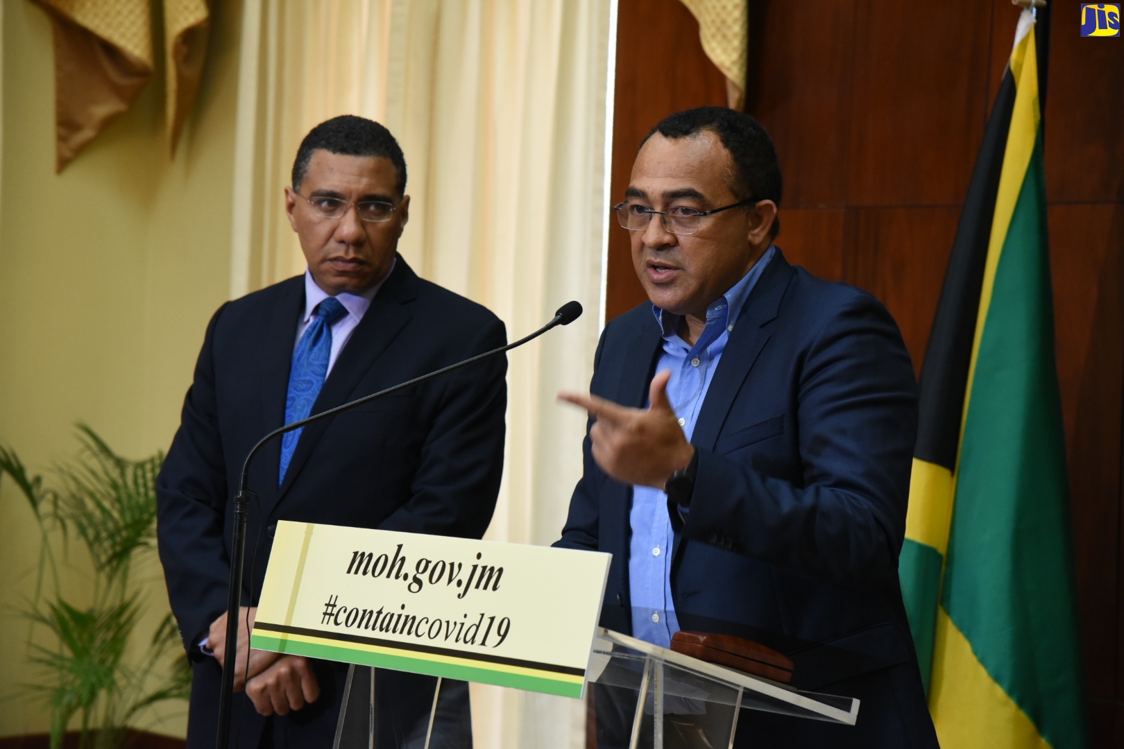 Minister of Health and Wellness, Dr. the Hon. Christopher Tufton, addressing the media during a press conference at Jamaica House on Monday (March 16). Looking on is Prime Minister, the Most Honourable Andrew Holness.
