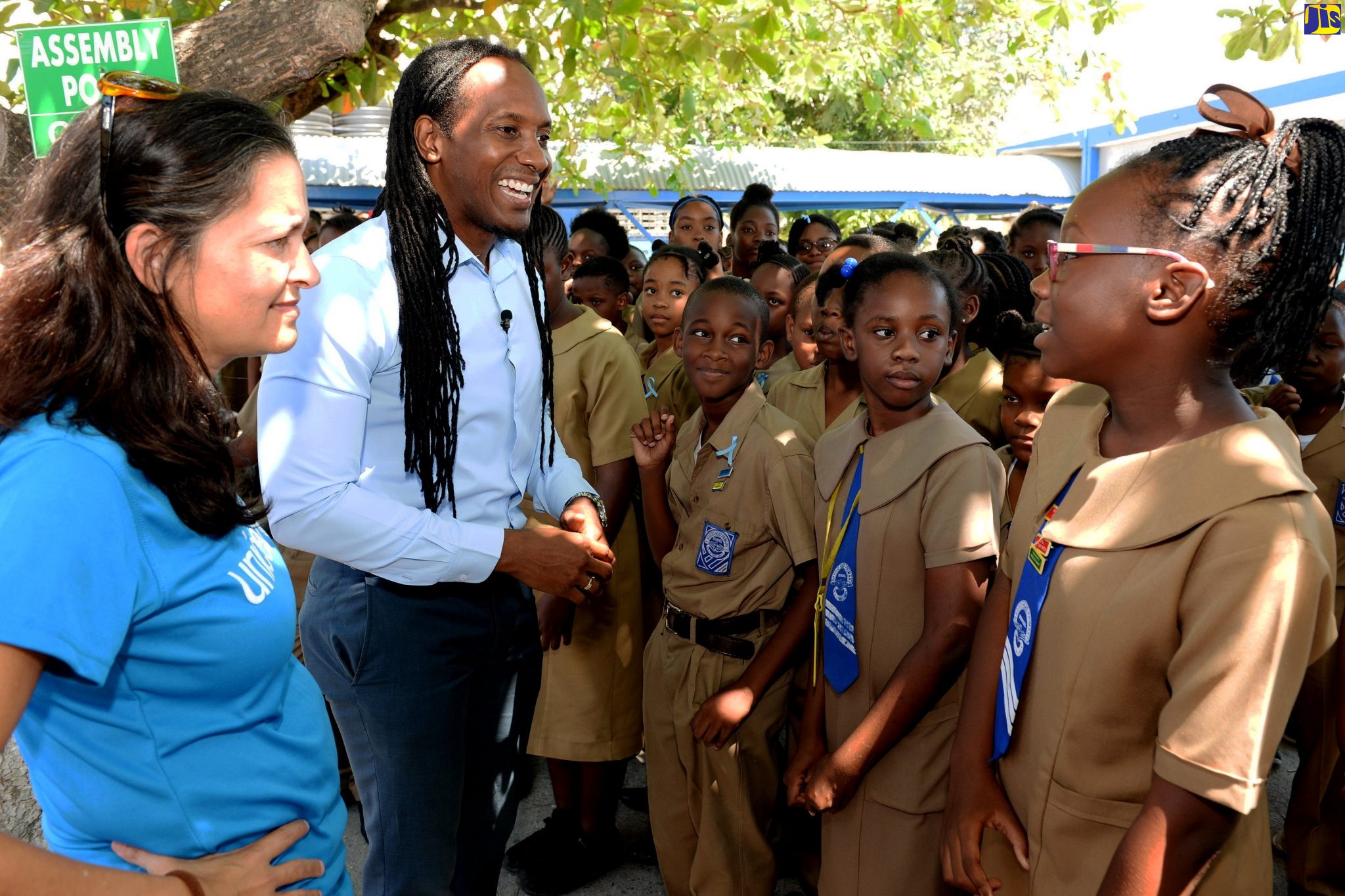 State Minister in the Ministry of Education, Youth and Information, Hon. Alando Terrelonge  (second left), engages with students of Naggo Head Primary School on Tuesday (March 3), while  Education Specialist, United Nations Children’s Fund (UNICEF), Dr. Rebecca Tortello (left), shares the moment. Occasion was National Peace Day actvities at the school under the theme ‘Peace is the Way for a Better Day’.