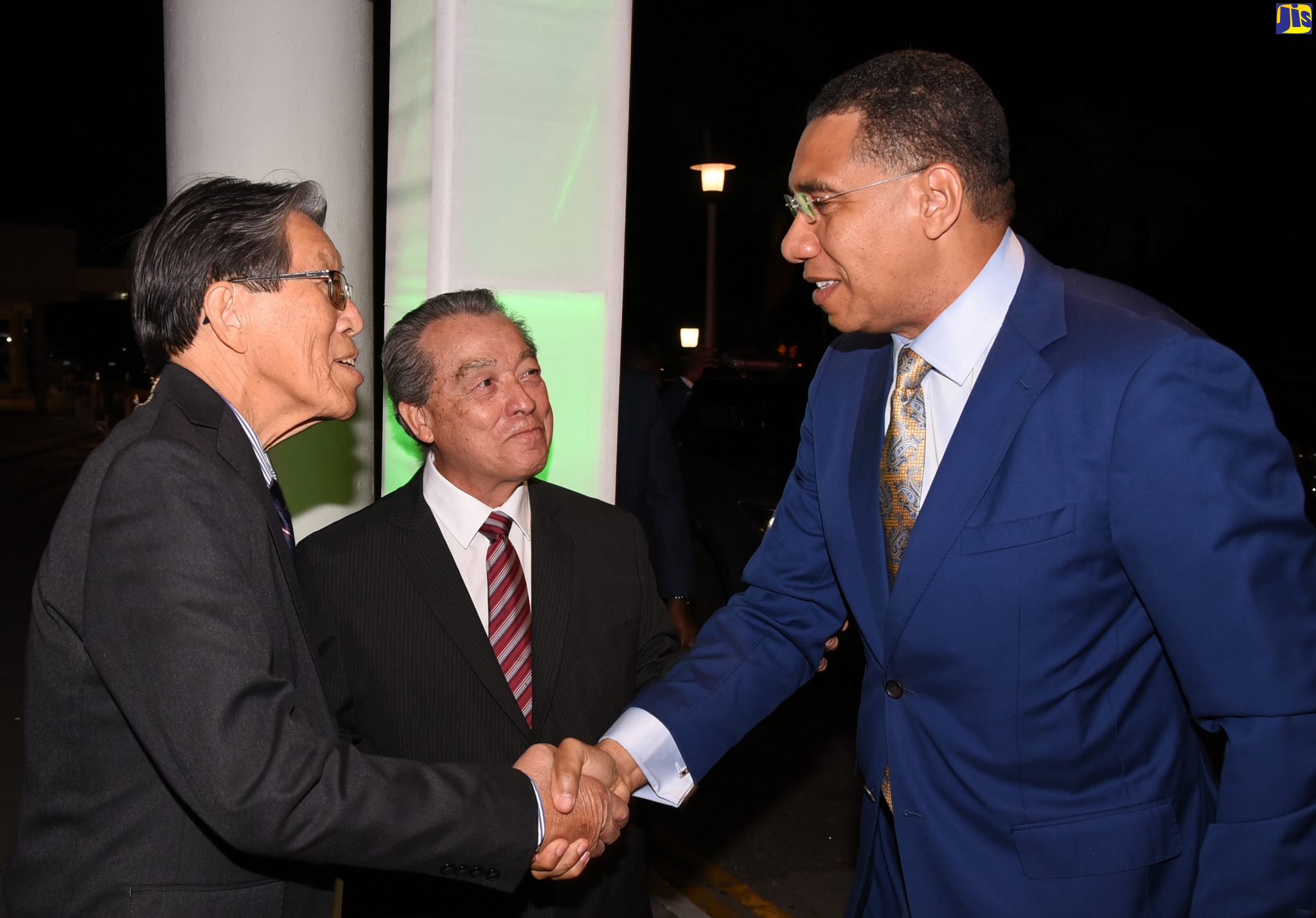 Prime Minister, the Most Hon. Andrew Holness (right), is greeted by Managing Director of Progressive Grocers,  Sing Chin (left), while the company's Chairman,  Albert Lym, looks on. The Prime Minister was the quest speaker at Progressive Grocers' 20th Anniversary Banquet held on Monday (March 19), at The Jamaica Pegasus hotel in New Kington.