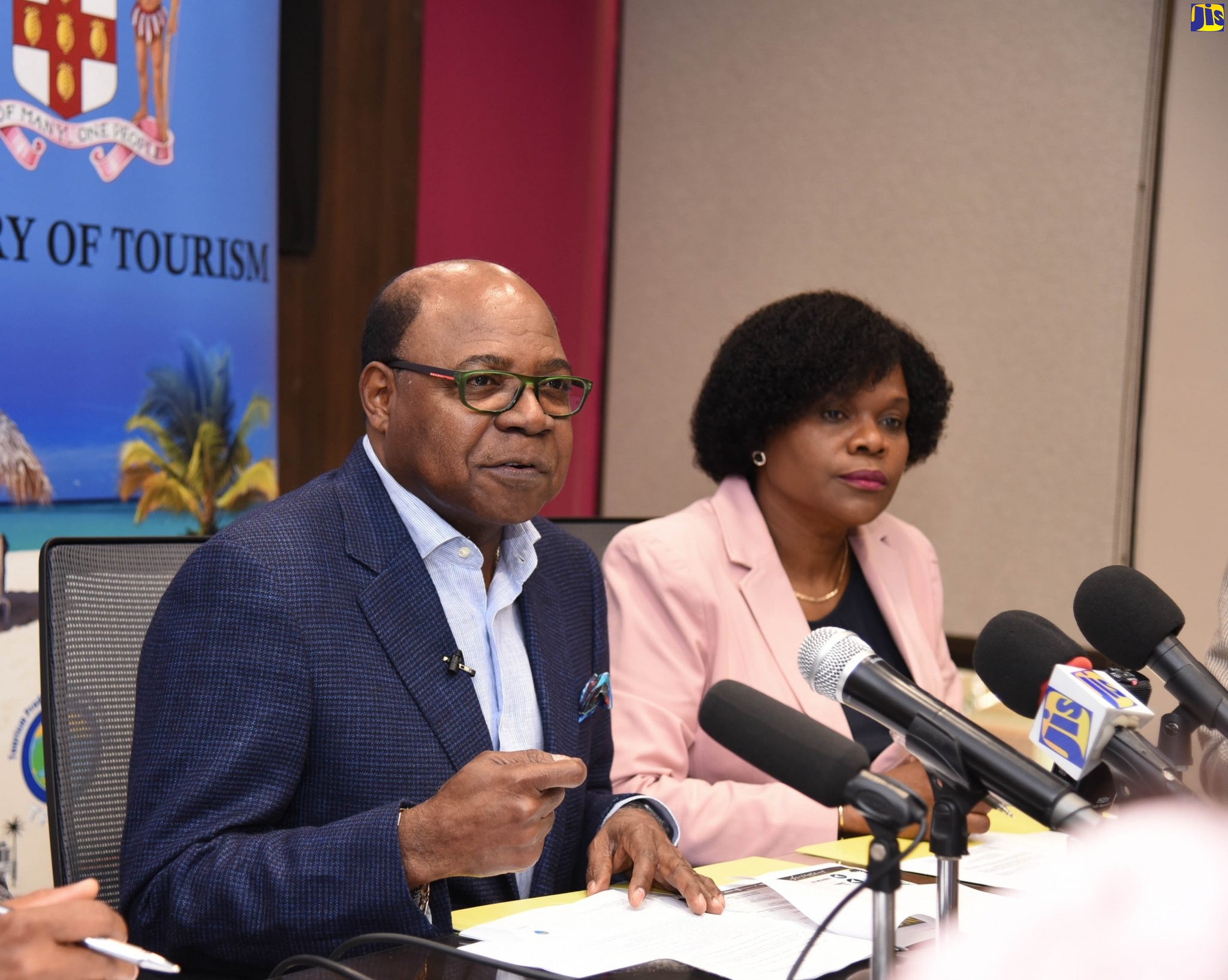 Minister of Tourism, the Hon. Edmund Bartlett (left), addressing a press briefing on Friday (March 13), at the Ministry