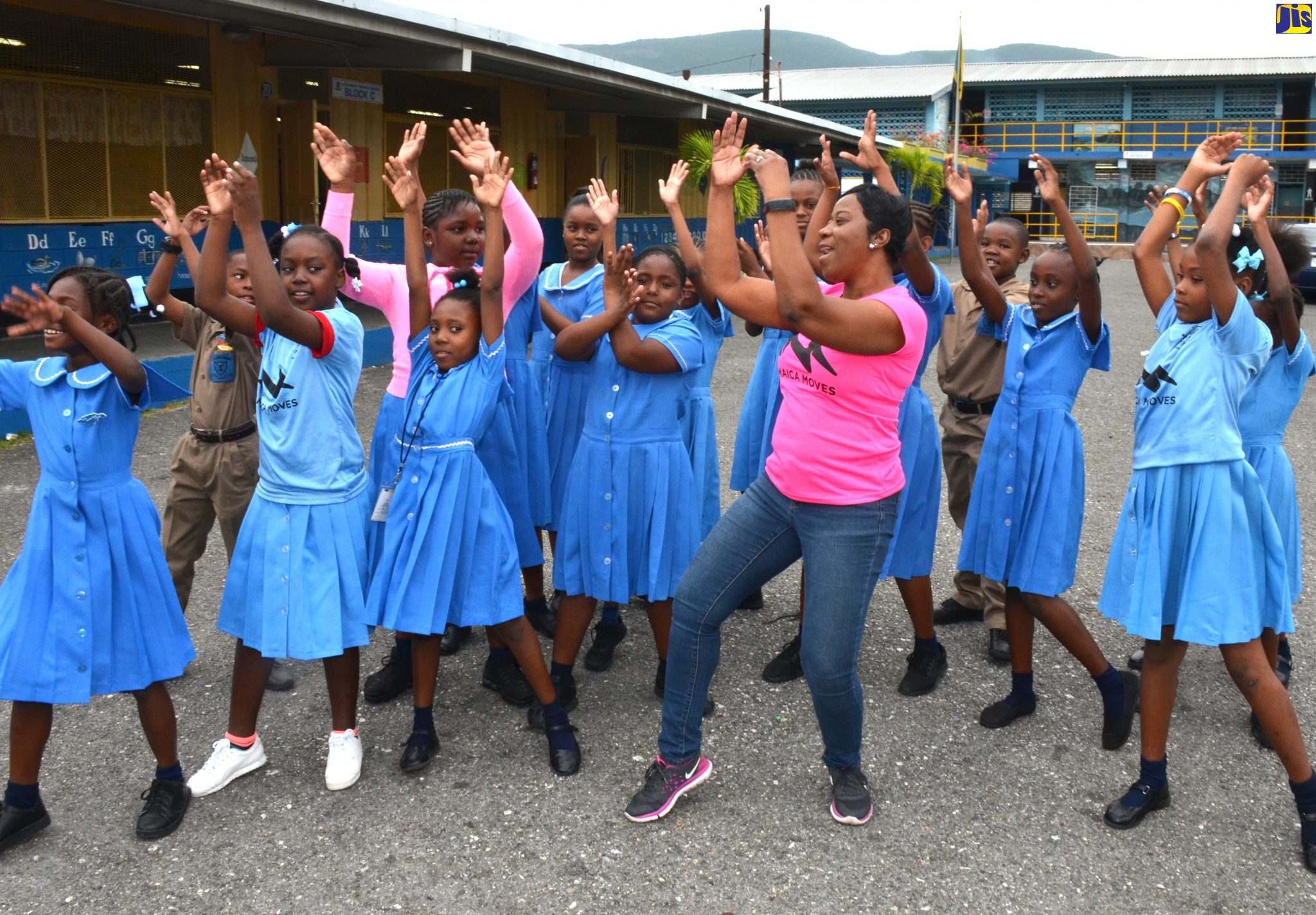 Behaviour Change Officer at the Ministry of Health and Wellness, Julia Manderson Steele (centre), engages students at the Clan Carthy Primary School in St. Andrew in ‘Jamaica Moves’ activities at the school.