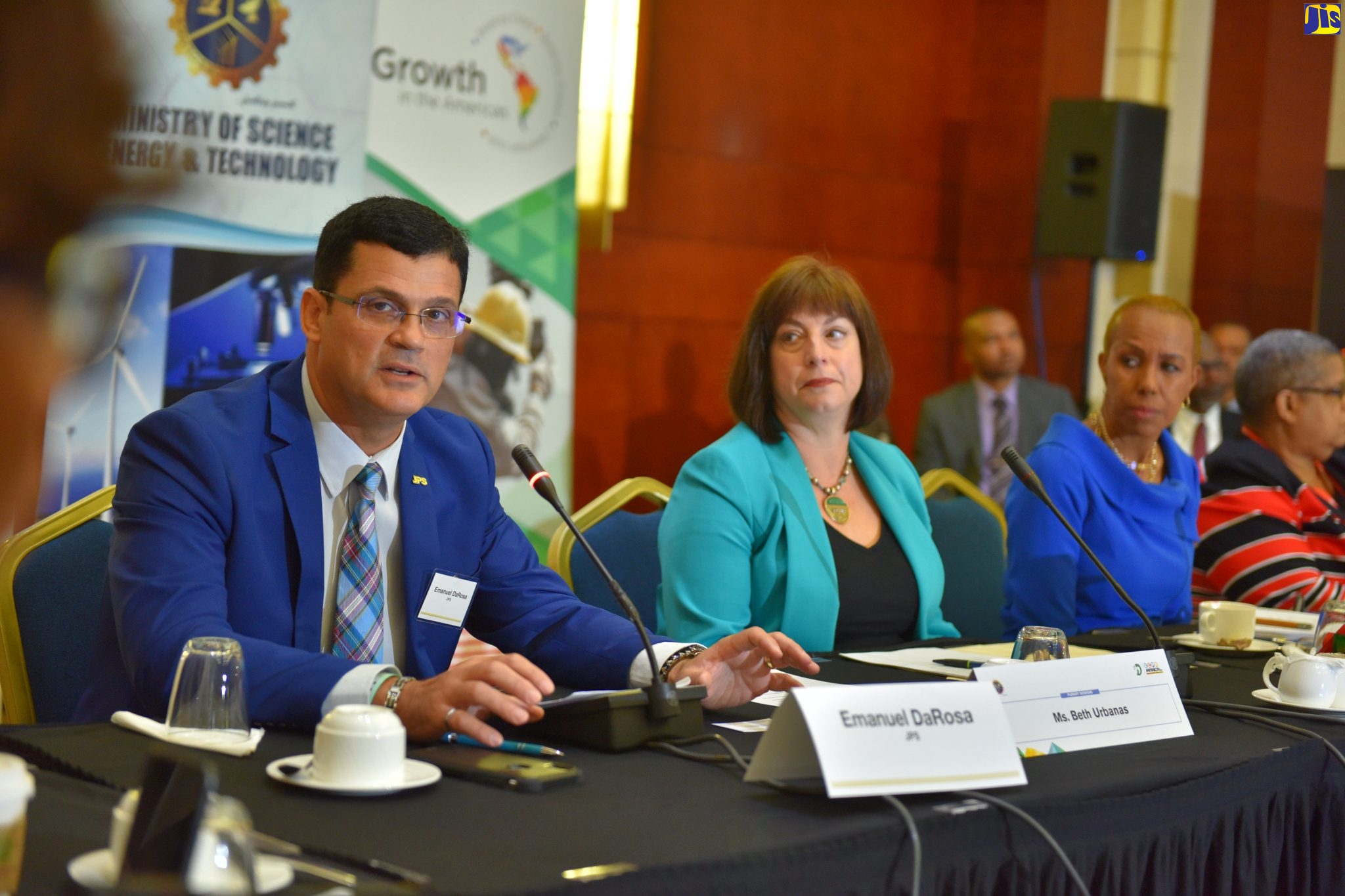 President and Chief Executive Officer of JPS, Emanuel DaRosa (left), speaks at the recent Energy Climate Partnership of Americas (ECPA) Ministerial Meeting, held at the Montego Bay Convention Centre, in St. James. Listening (from second left) are Deputy Assistant Secretary for Asia and the Americas at the Office of International Affairs in the US Department of Energy, Beth Urbanas; and Minister of Science, Energy and Technology, Hon. Fayval Williams.