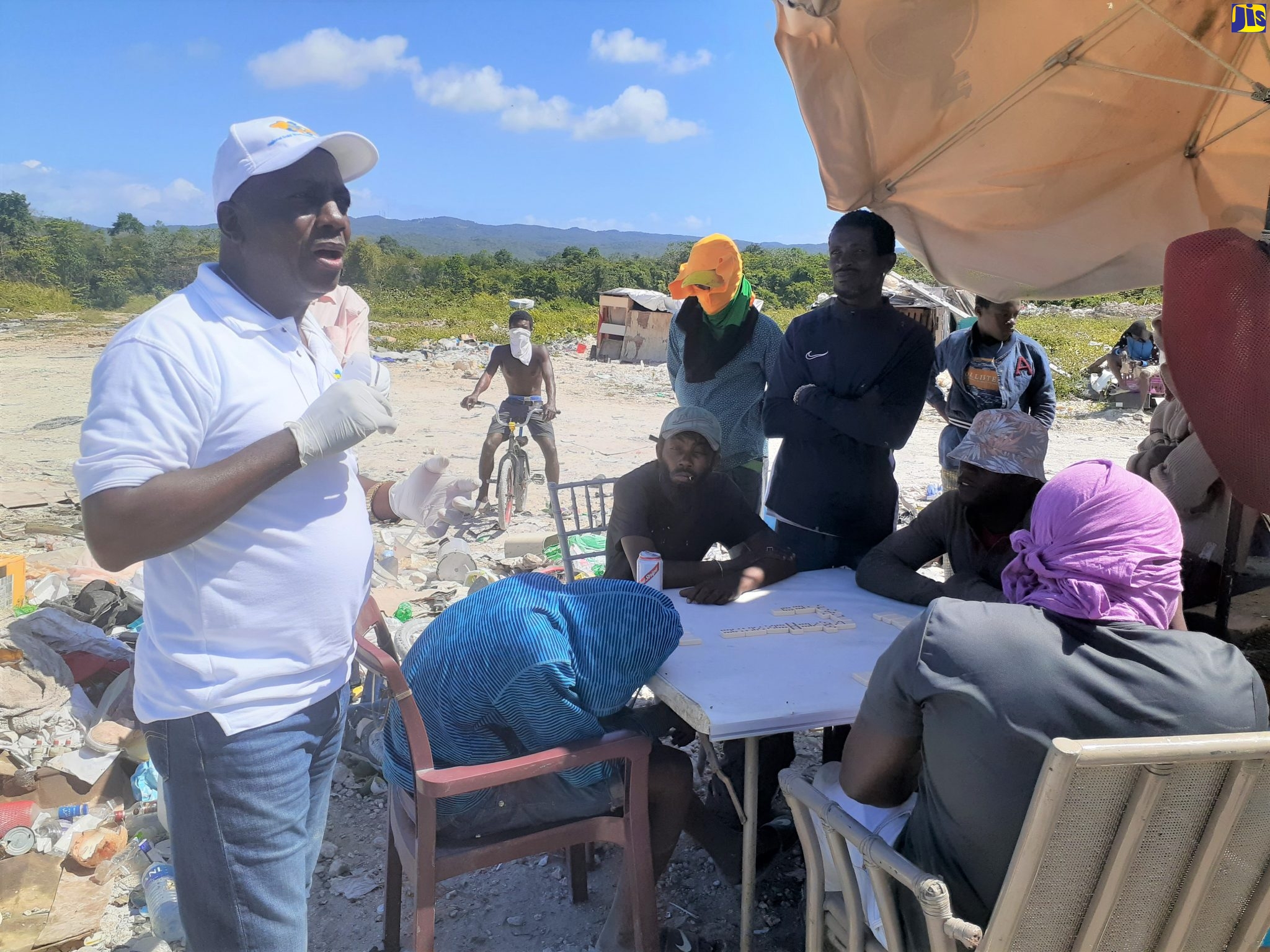 Executive Director of the National Solid Waste Management Authority (NSWMA), Audley Gordon (left), speaks to residents at the Retirement landfill in St. James, on Wednesday (March 18).