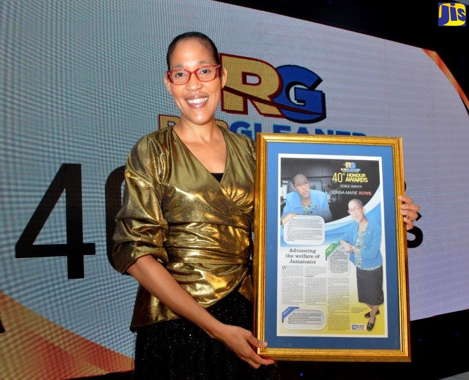 A delighted Chief Executive Officer (CEO) of  the Jamaica Information Service (JIS), Mrs. Donna-Marie Rowe, with  her  RJRGleaner  40th Honour Award for Public Service, which was presented to her  at the Awards Dinner, held at the Jamaica Pegasus Hotel, in Kingston, on February 28.