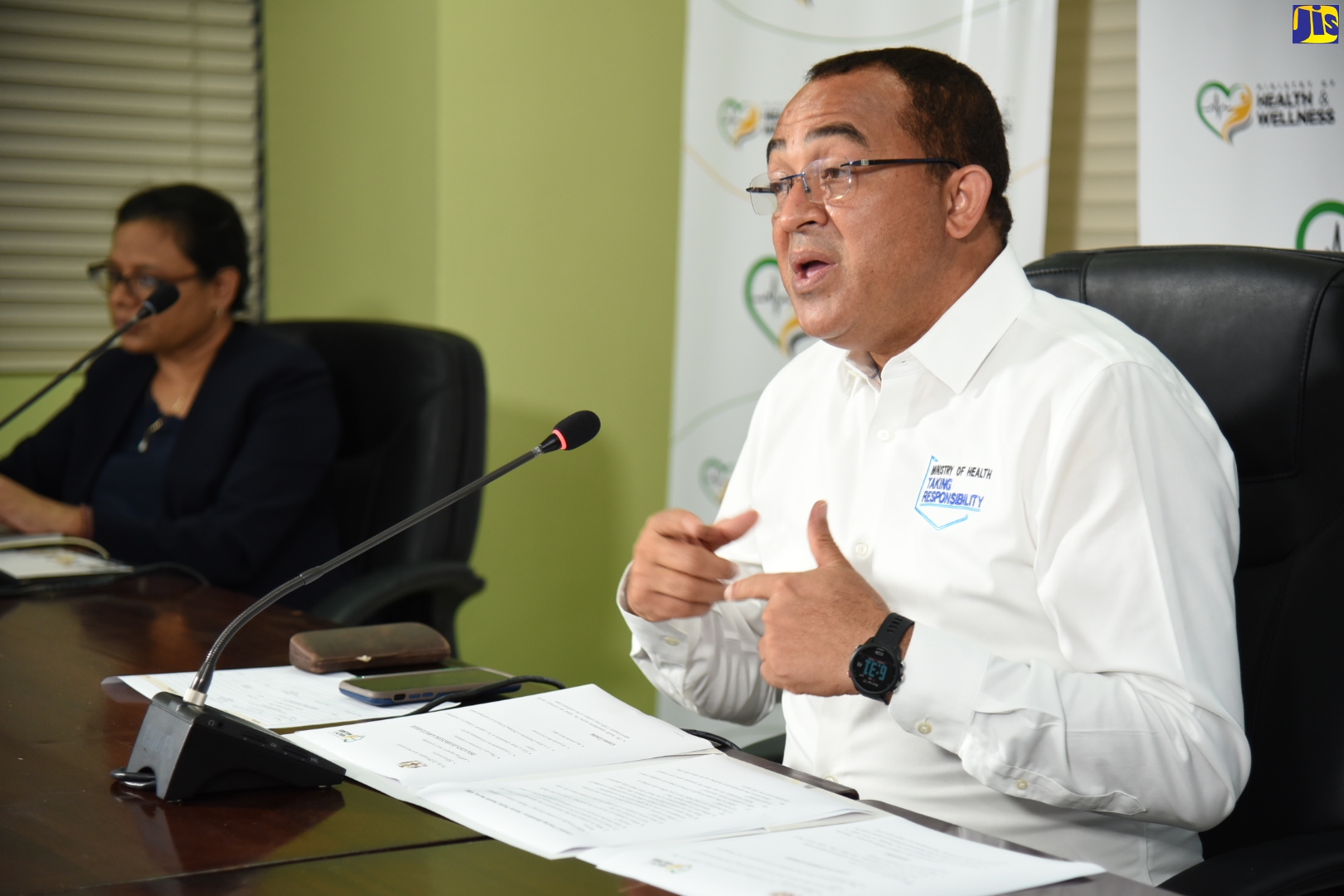 Minister of Health and Wellness, Dr. the Hon. Christopher Tufton (right), highlights a point while responding to questions from journalists, during a digital press conference on Wednesday (April 22). At left is Chief Medical Officer, Ministry of Health and Wellness, Dr. Jacquiline Bisasor-McKenzie.