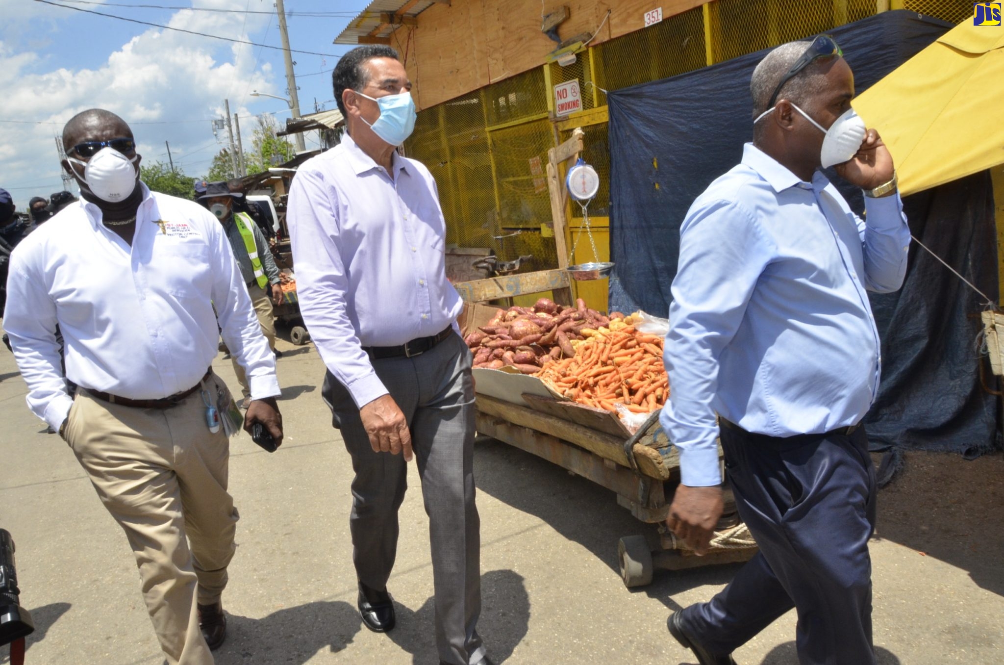 Mayor of Montego Bay, Councillor Homer Davis (centre); and Manager of the St. James Public Health Department, Lennox Wallace (left), are being led on a tour of the Charles Gordon Market on Thursday (April 23) by Market Manager, Mikoyan Robinson.