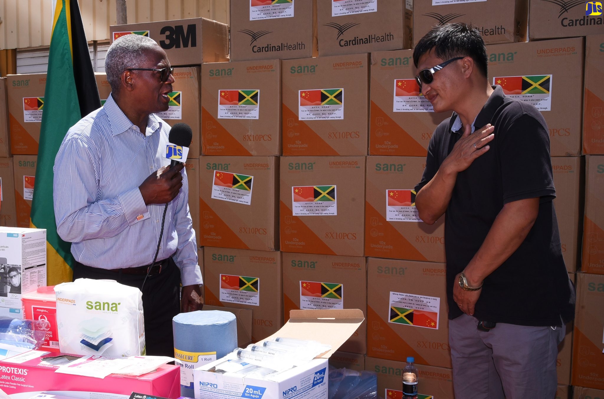 Board Chairman, South East Regional Health Authority (SERHA), Wentworth Charles (left), expresses gratitude to member of the Chinese community in Jamaica, Zipling Chen, for the donation of an assortment of personal protective equipment to the Kingston Public Hospital (KPH). The equipment, valued at $3 million, which will help protect healthcare workers from exposure to the coronavirus (COVID -19), was handed over on Tuesday (March 31), at the Garmex Free Zone, Kingston.