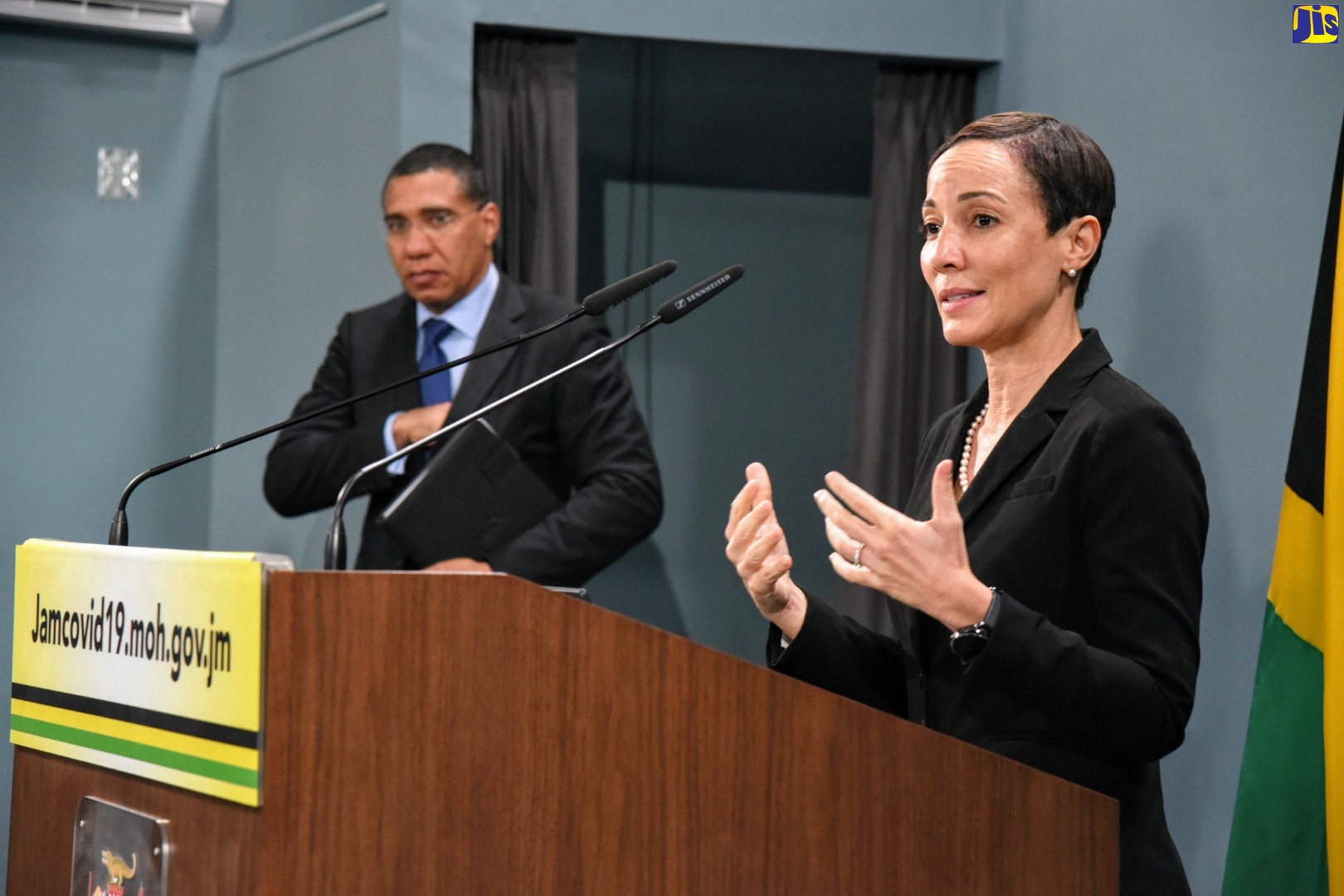 Minister of Foreign Affairs and Foreign Trade, Senator the Hon. Kamina Johnson Smith, addresses a digital press conference from Jamaica House on Monday (April 20). Looking on is Prime Minister, the Most Hon. Andrew Holness.