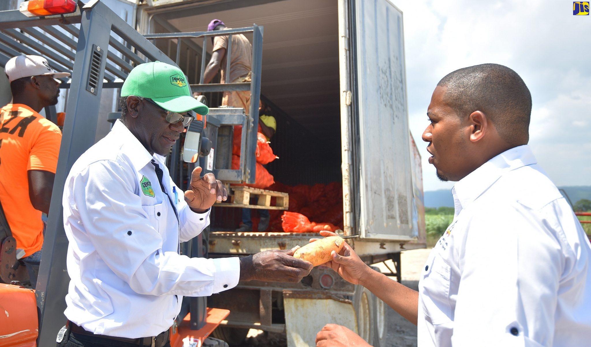 Minister of State in the Ministry of Industry, Commerce, Agriculture and Fisheries, Hon. Floyd Green (right), in discussion with Vice President of Dencon Foods Limited, Nicholas Duke, at the company