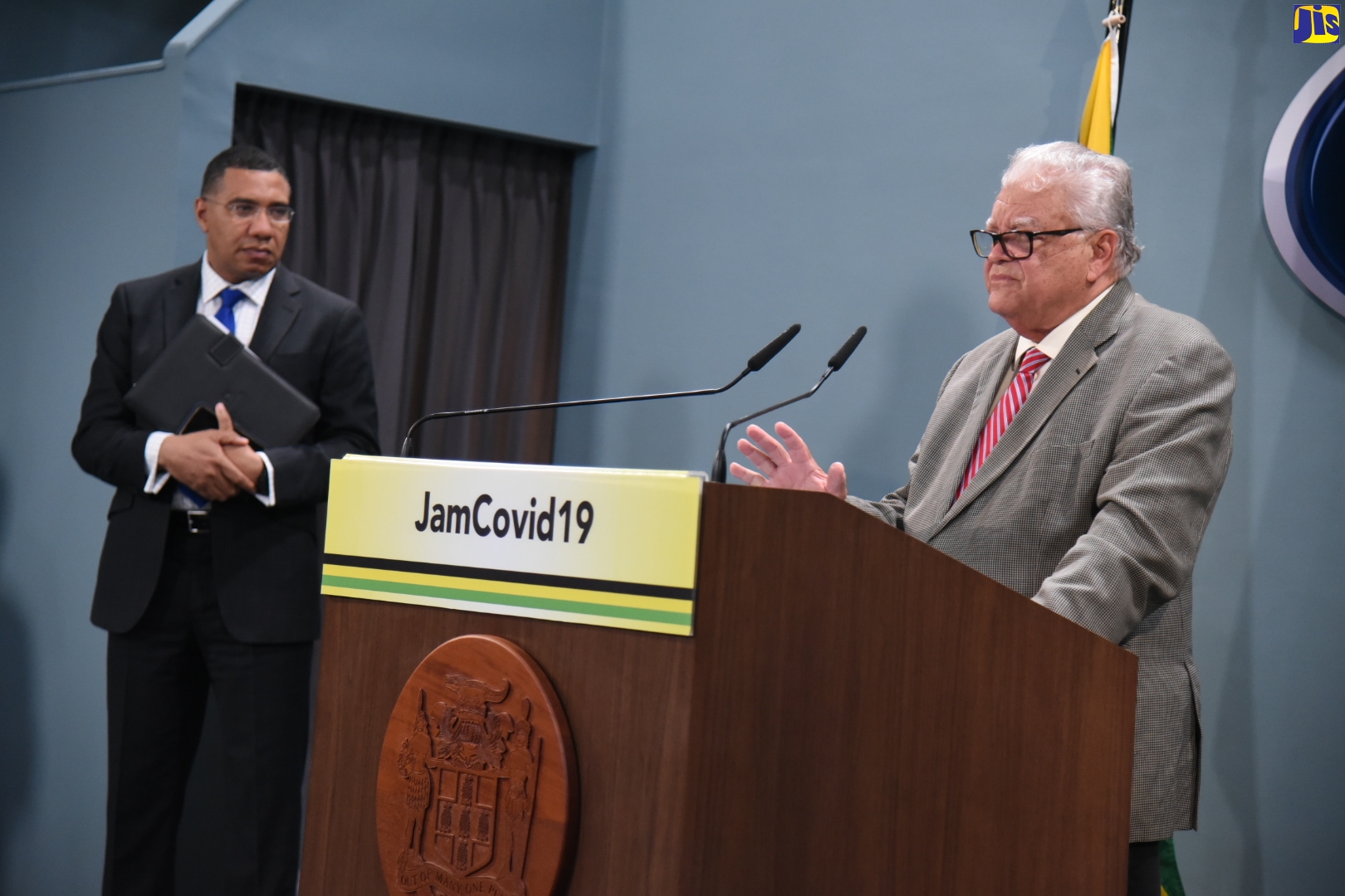 Prime Minister, The Most Hon. Andrew Holness (left), looks on as Minister with responsibility for Education, Youth and Information, Hon. Karl Samuda, provides an update on the sector during a digital press briefing at the Office of the Prime Minister on May 4.