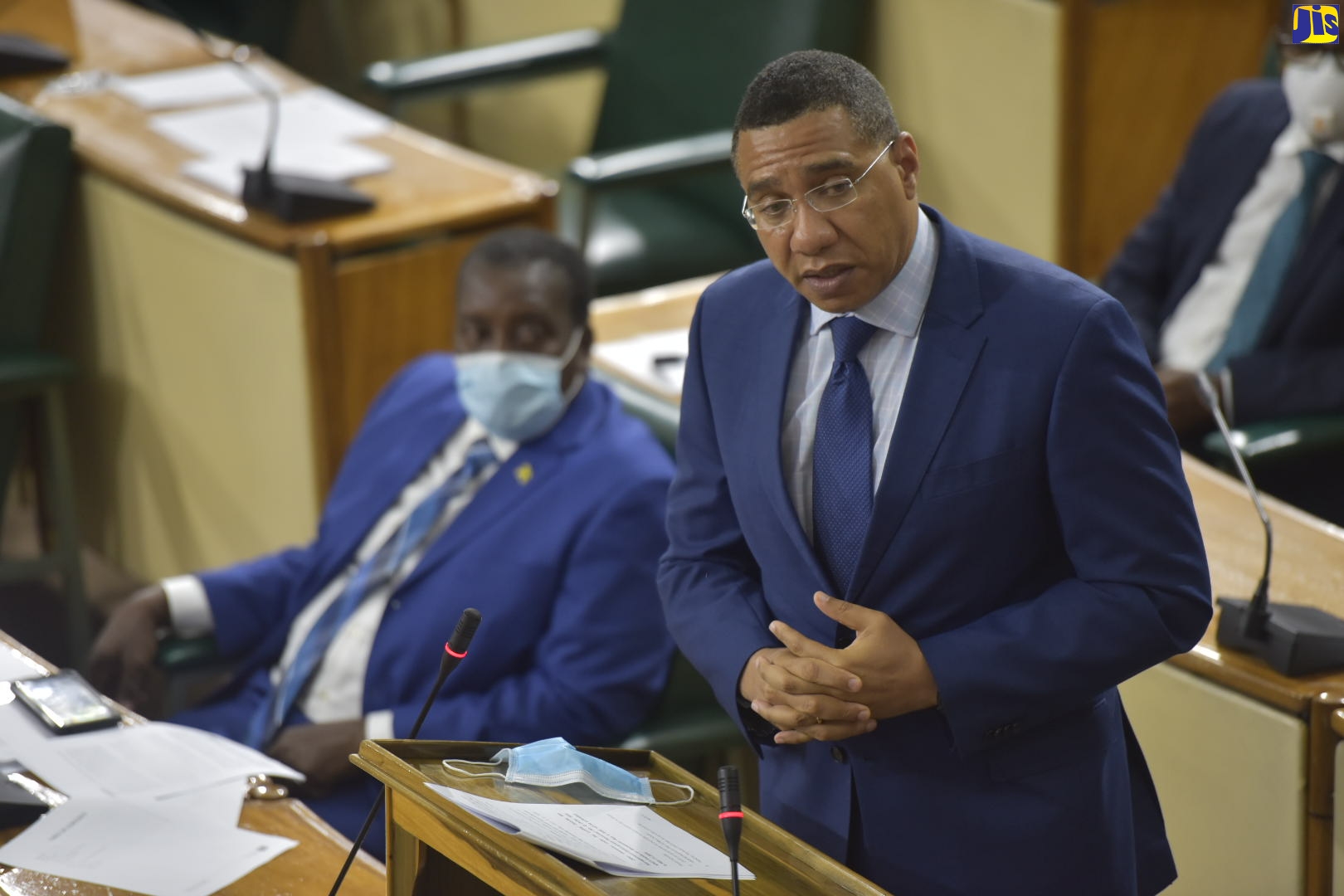 Prime Minister, the Most Hon. Andrew Holness, speaking during a sitting of the House of Representatives on May 5. At left is Minister of Transport and Mining, Hon. Robert Montague.