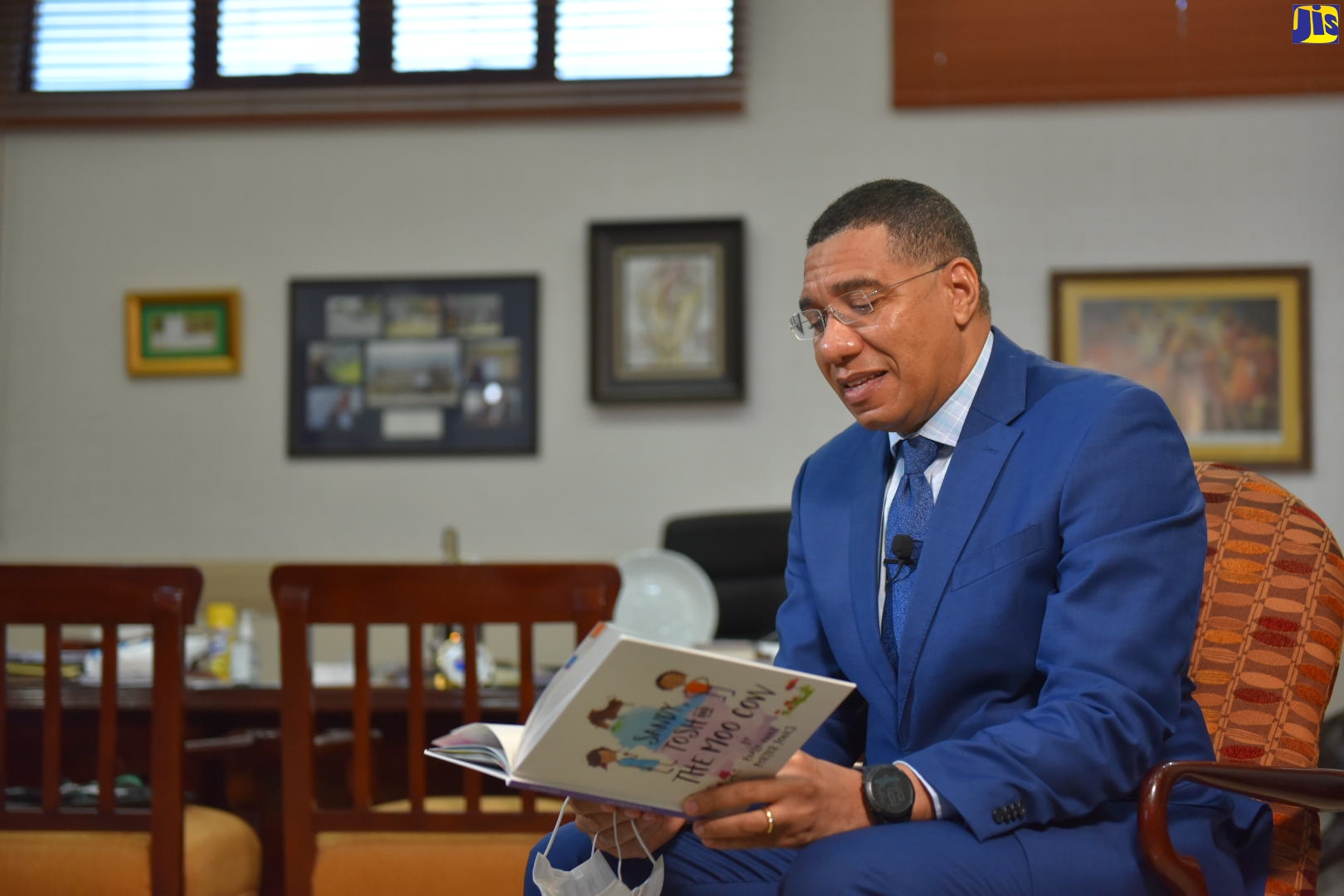 Prime Minister, the Most Hon. Andrew Holness, reads to children from the storybook, titled, ‘Sandy, Tosh and the Moo Cow’, by Paula-Ann Porter Jones, during Read Across Jamaica Day activities, Tuesday, May 5, from his offices in St. Andrew. This year’s staging of the annual interactive event was done online as part of measures to contain and minimise the spread of the coronavirus (COVID-19).