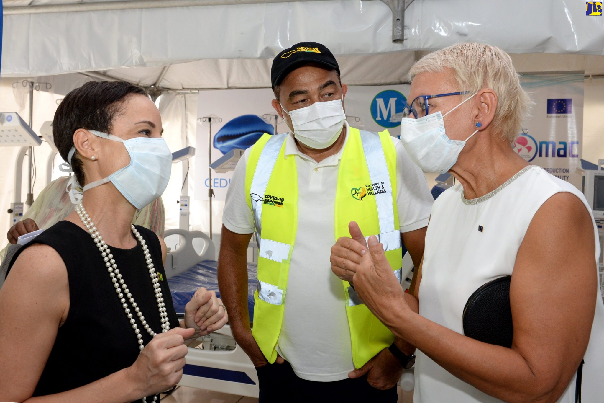 Minister of Foreign Affairs and Foreign Trade, Senator the Hon. Kamina Johnson Smith (left); and Minister of Health and Wellness, Dr. the Hon. Christopher Tufton (centre), listen to Head of the European Union Delegation to Jamaica, Ambassador Malgorzata Wasilewska, at the handover of medical equipment from the EU to Jamaica, at Medical Link Limited in St. Andrew, on May 20.
