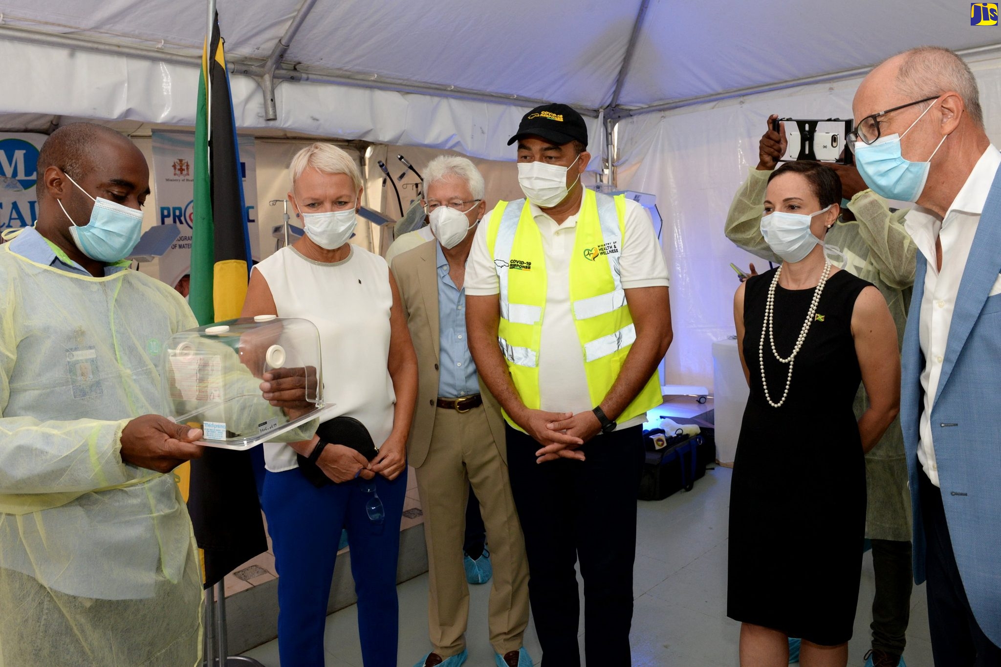 Minister of Foreign Affairs and Foreign Trade, Senator the Hon. Kamina Johnson Smith (second right), and Minister of Health and Wellness, Dr. the Hon. Christopher Tufton (third right), observe while Technical Director at Medical Link Limited, Lensworth Blake (left), highlights features of one of several pieces of medical equipment valued at approximately $80 million that the European Union (EU) has donated to the public health system. The items were handed over during a ceremony held on Wednesday (May 20), at Medical Link Limited in St. Andrew. Others (from second left) are Head of the EU Delegation to Jamaica, Ambassador Malgorzata Wasilewska;  German Ambassador to Jamaica, Dr. Bernd Von Munchow-Pohl; and Ambassaor of France to Jamaica, Denys Wibaux.